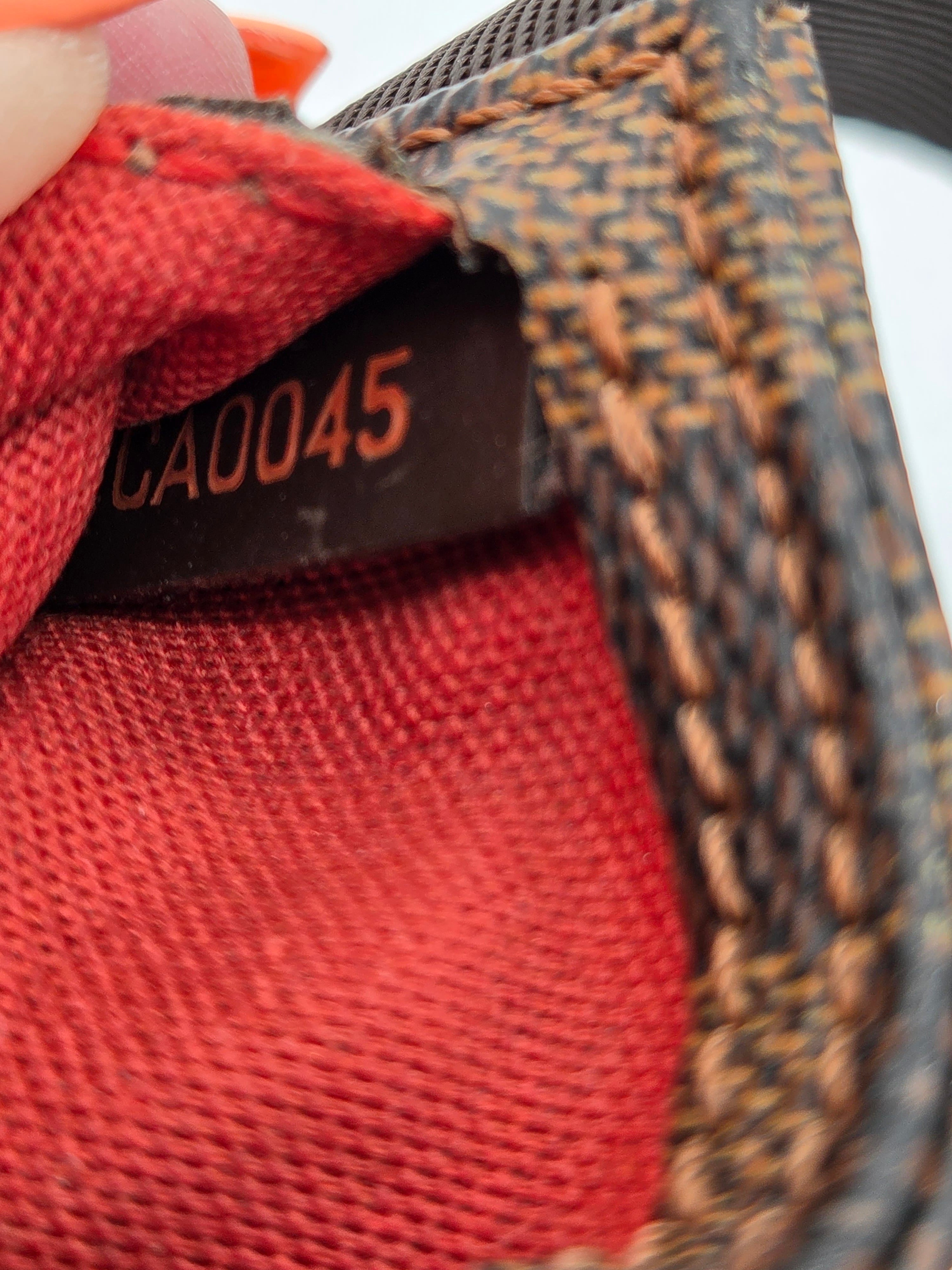Close-up of a textured surface with a red fabric patch and a visible label.