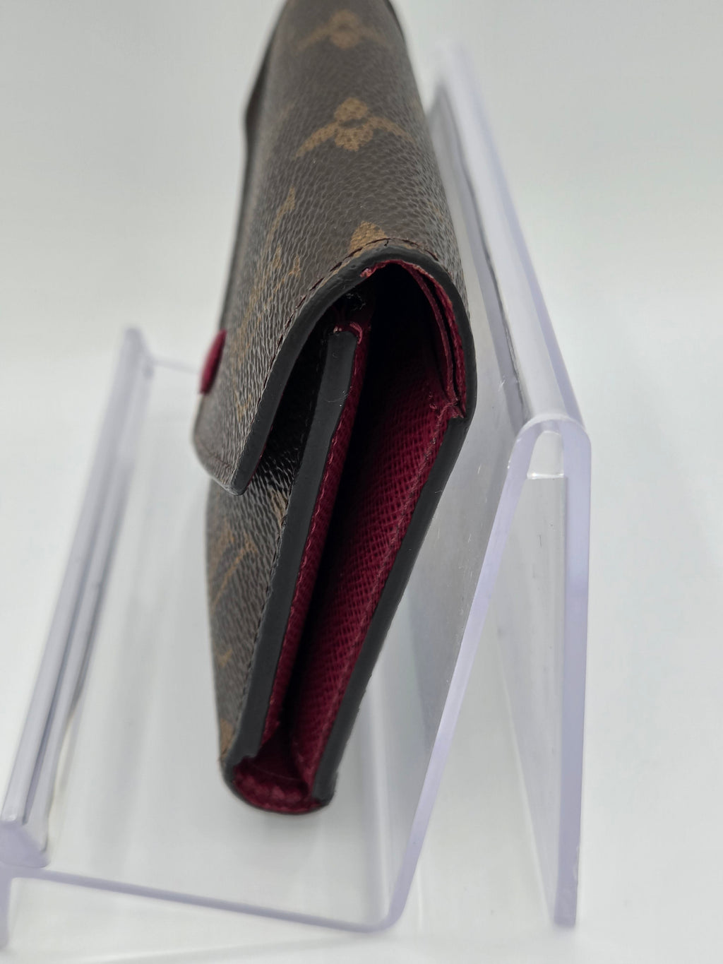 Louis Vuitton shoe in a clear box on a white background