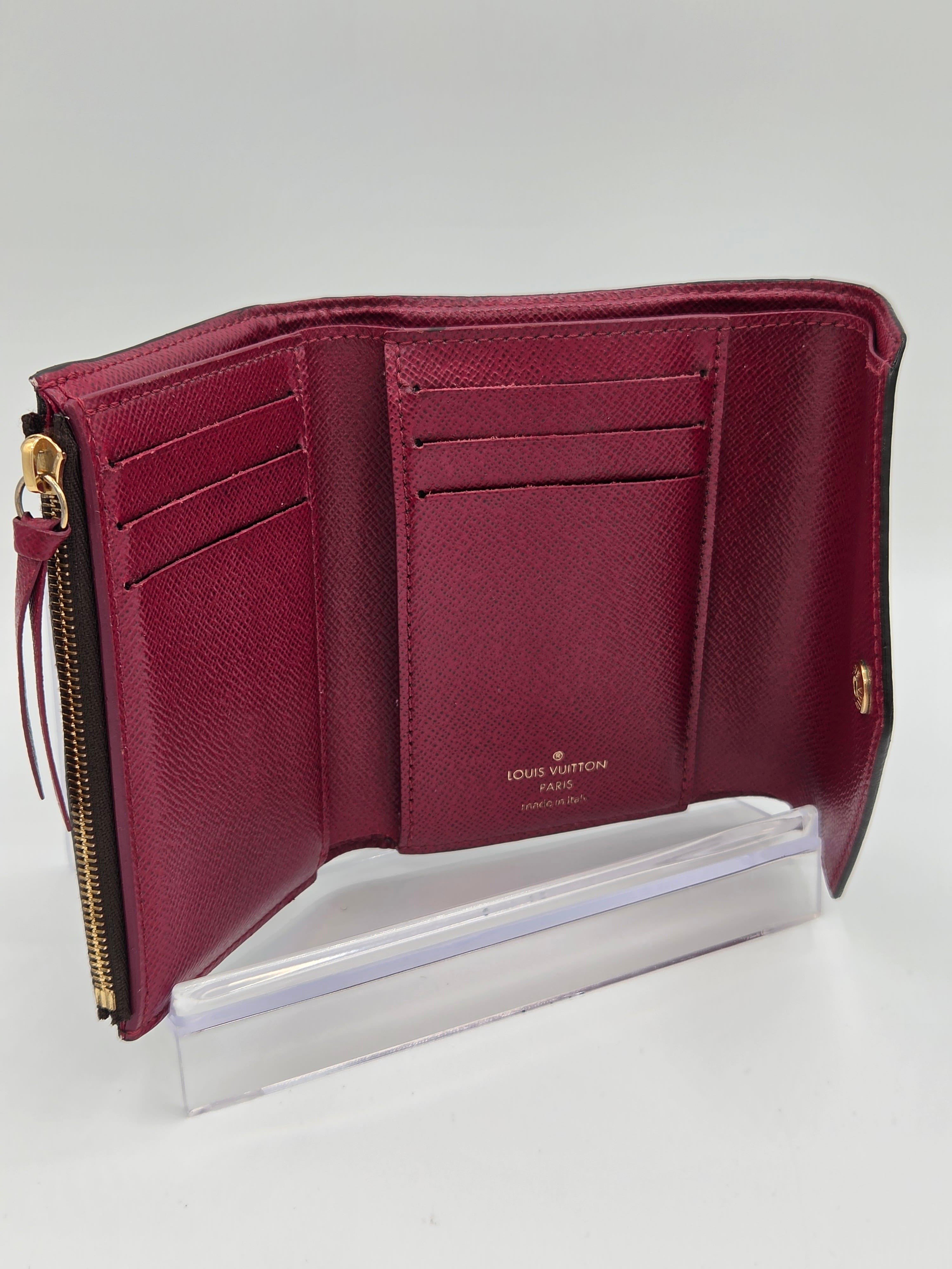 Maroon wallet with gold accents on a white background