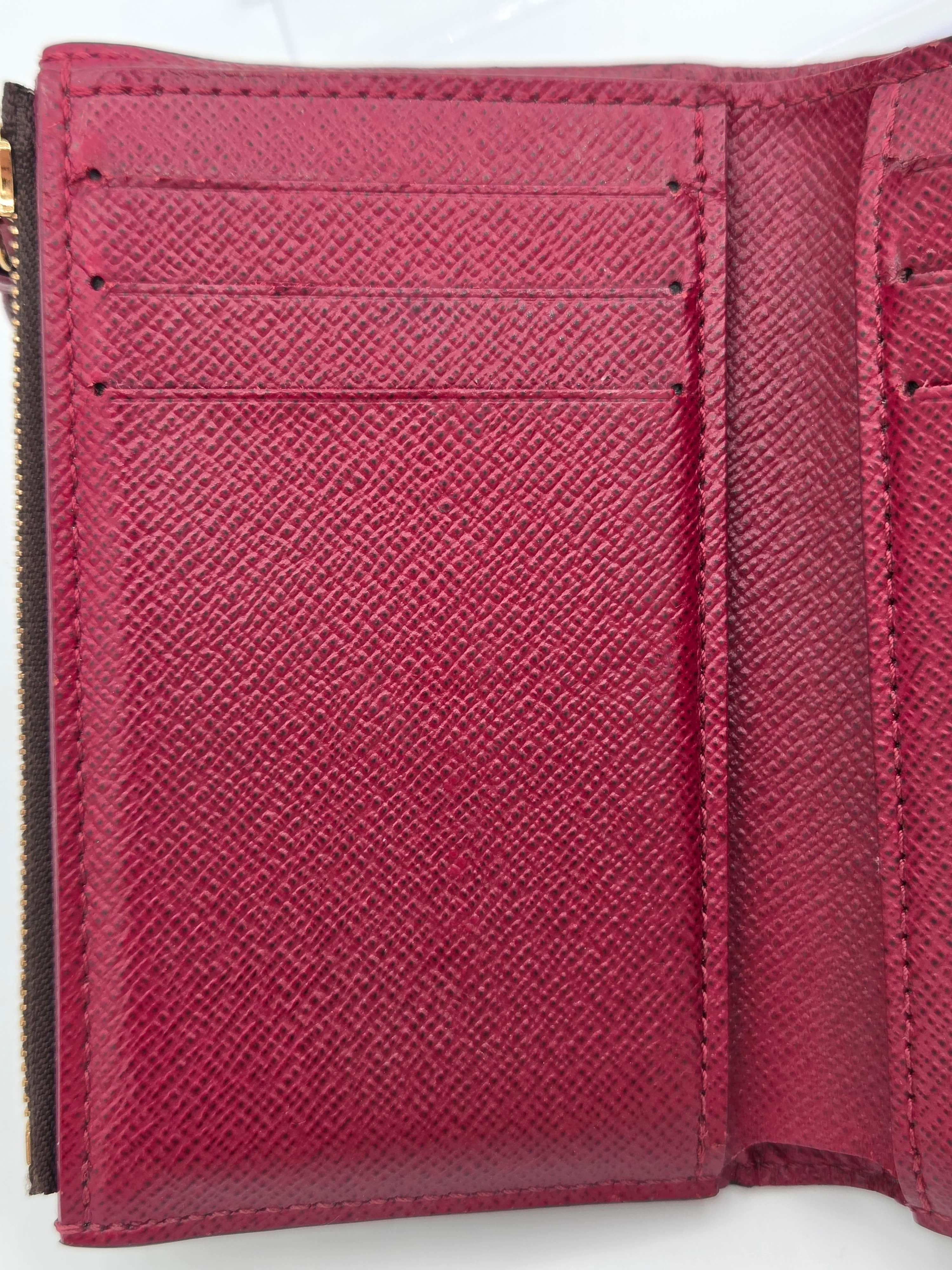 Close-up of a pink wallet with a textured surface on a white background