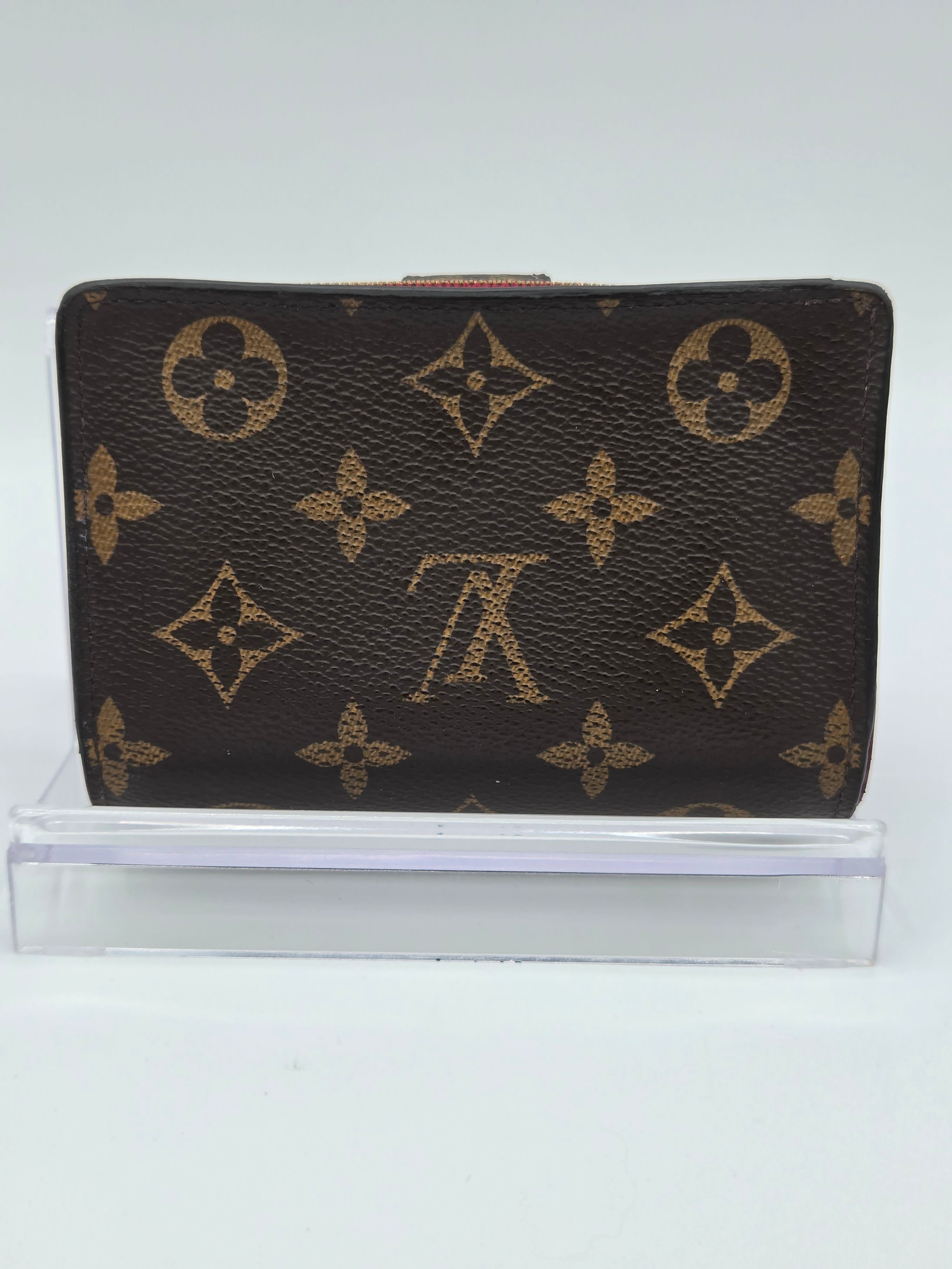 Designer wallet with monogram pattern on a white background