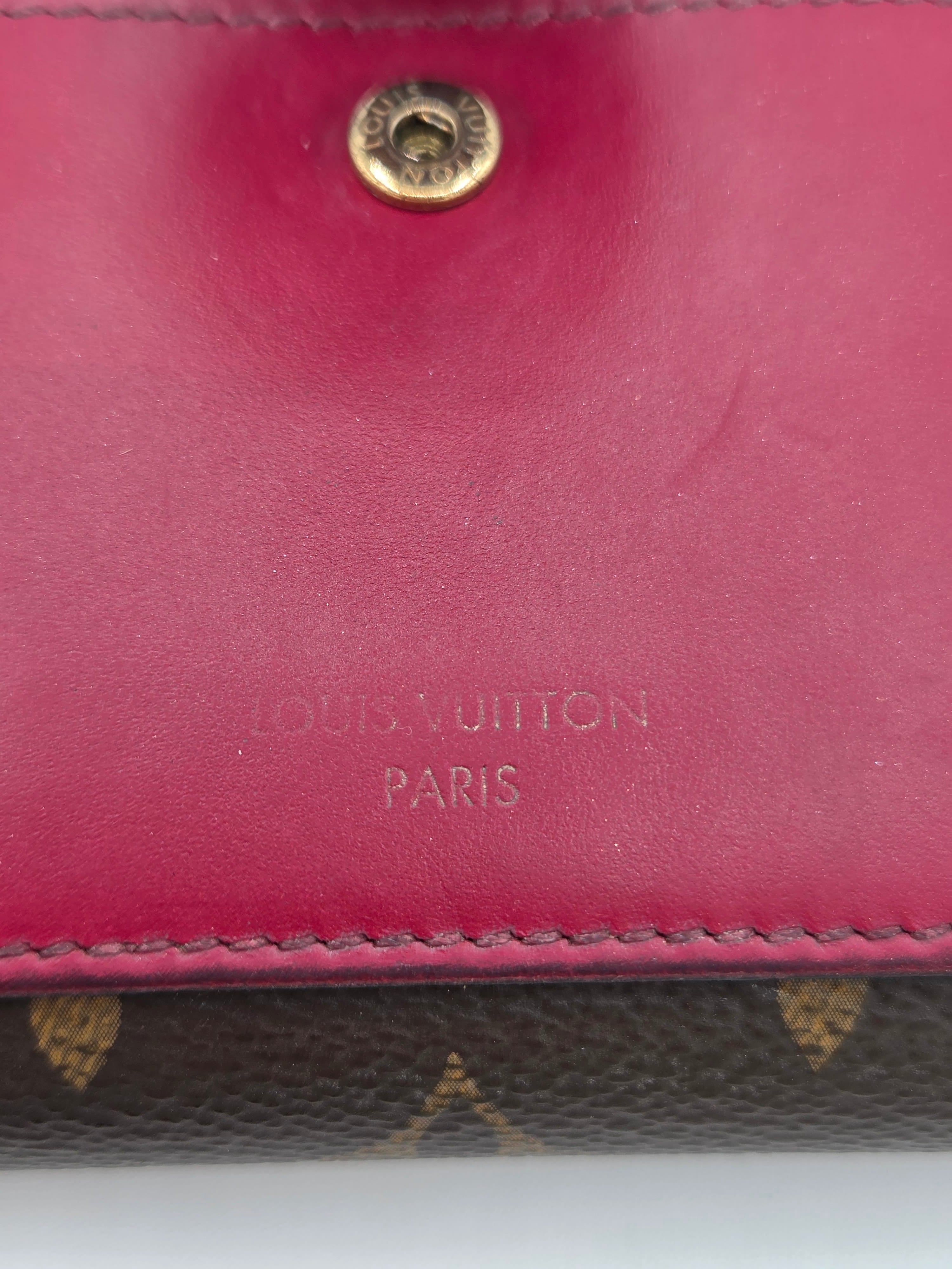 Close-up of a Louis Vuitton wallet with visible branding.