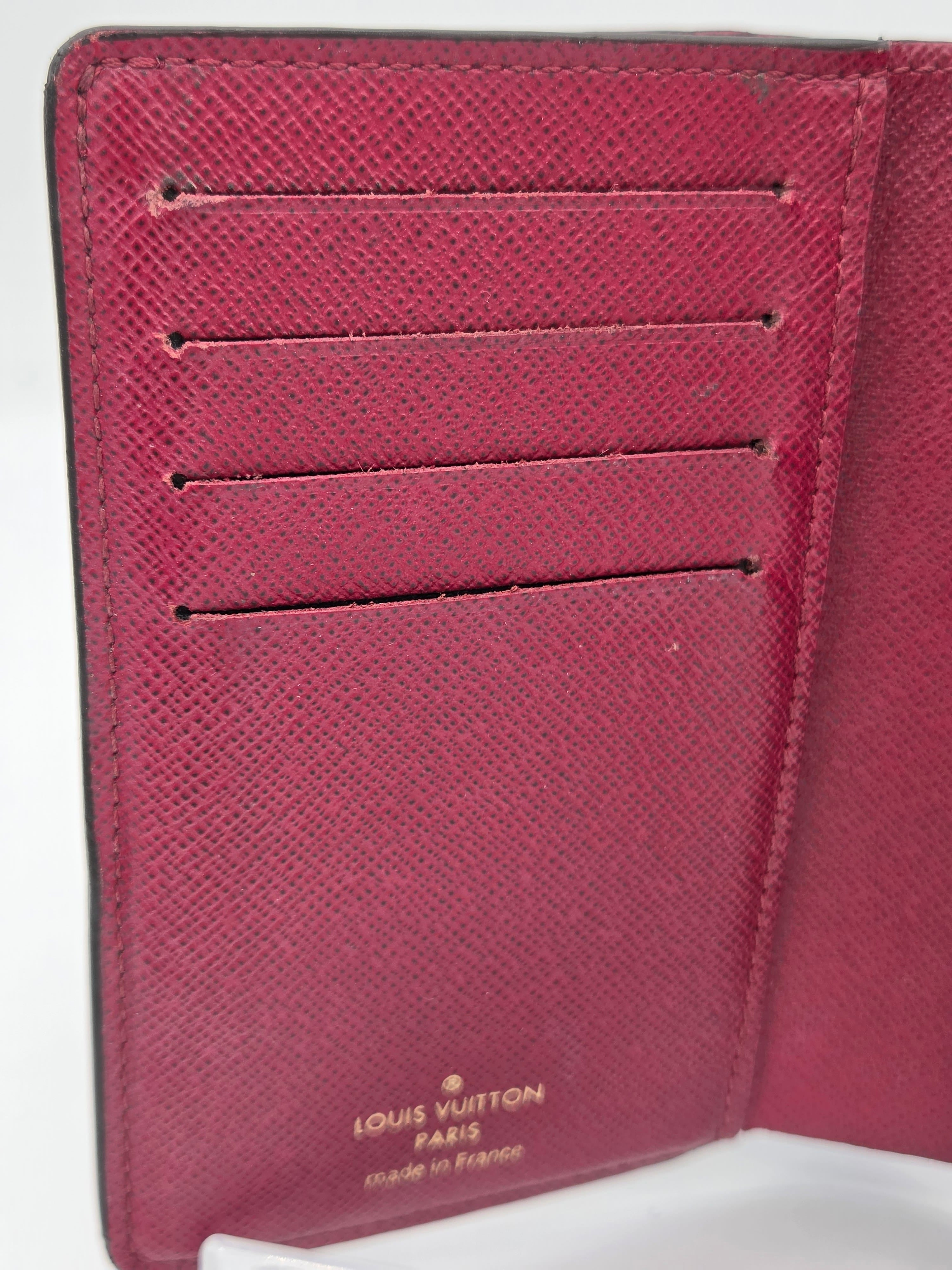 Close-up of a maroon Louis Vuitton wallet on a white background