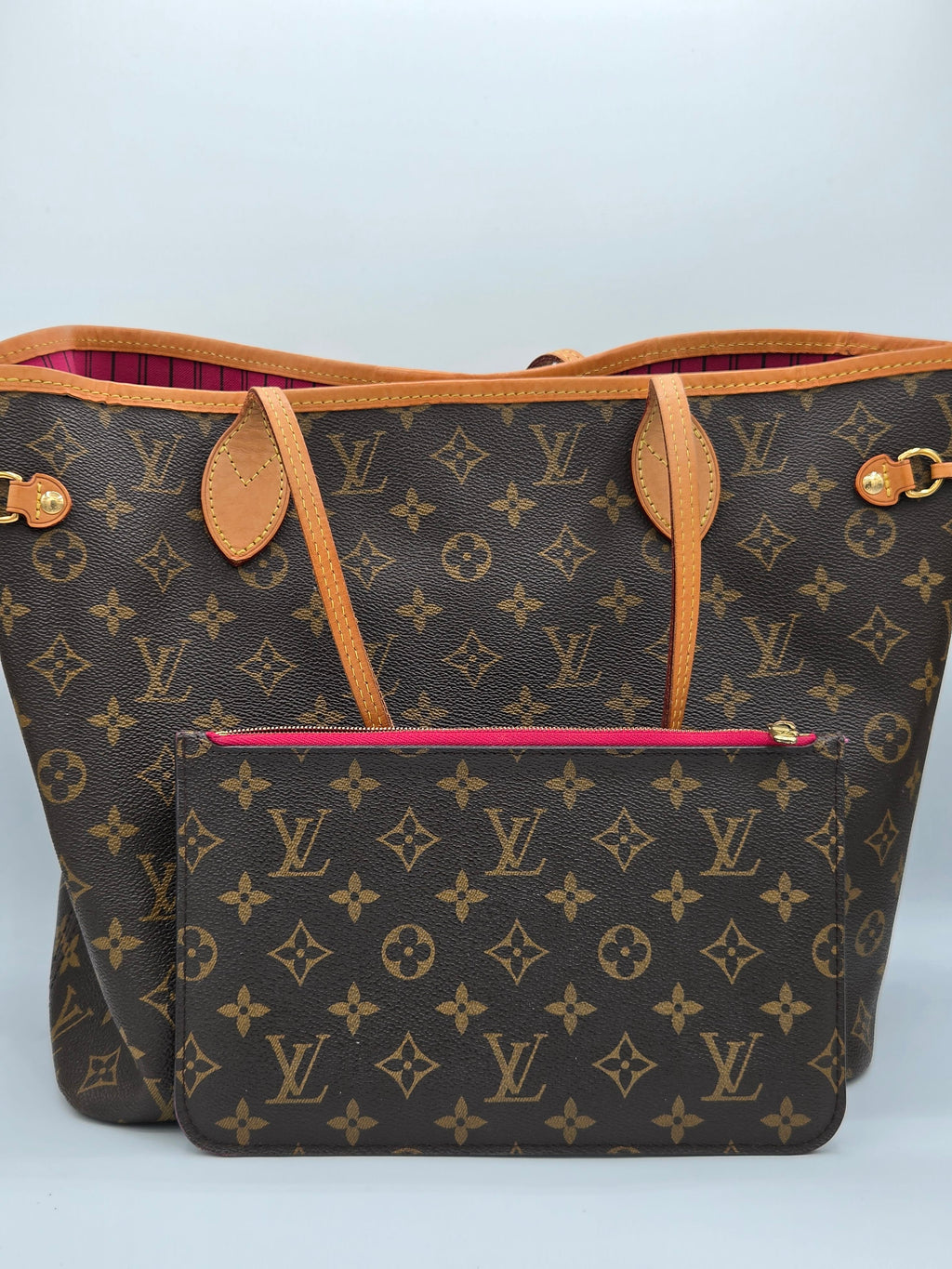 Designer handbag with monogram pattern on a light gray background