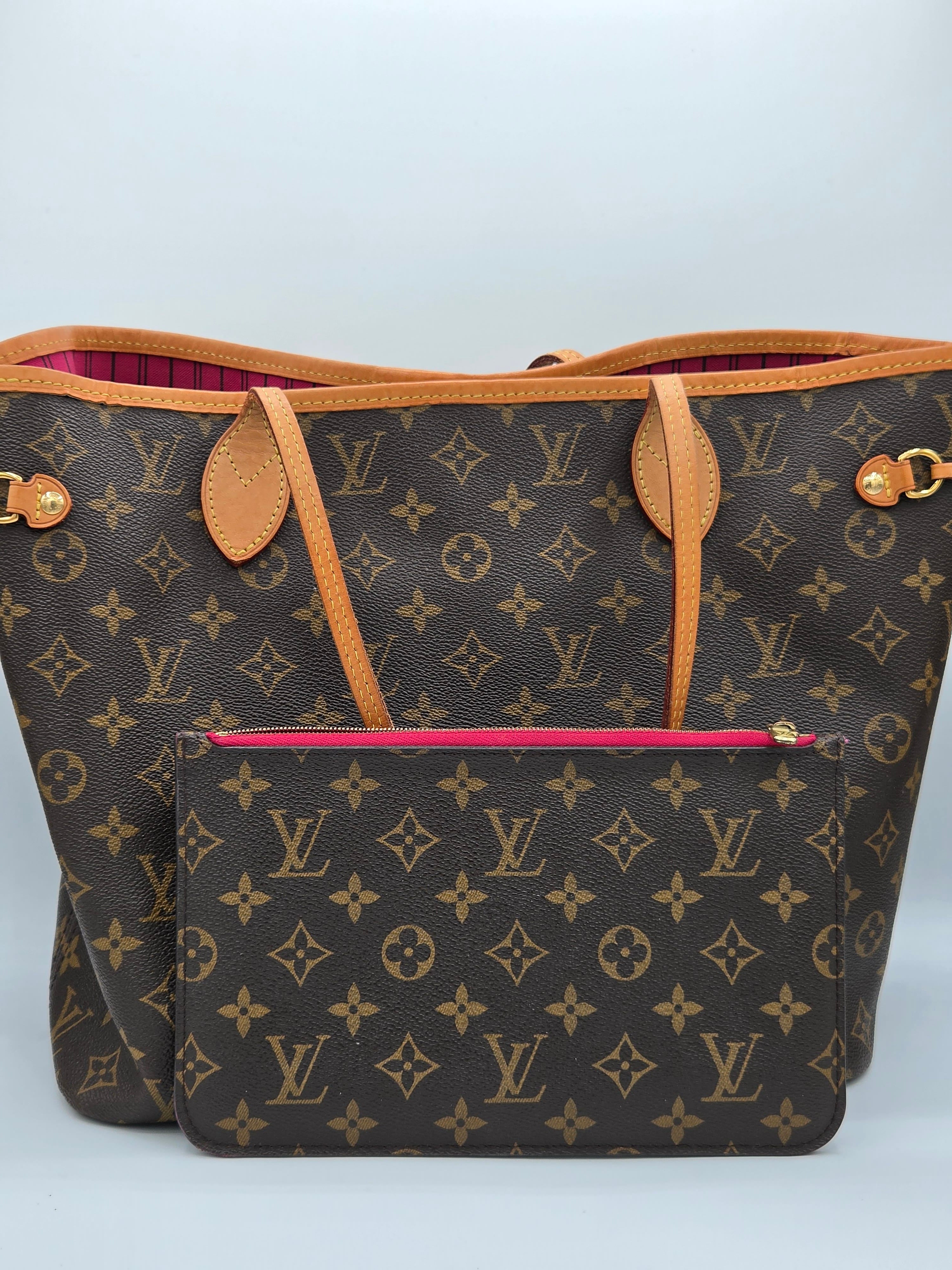 Designer handbag with monogram pattern on a light gray background