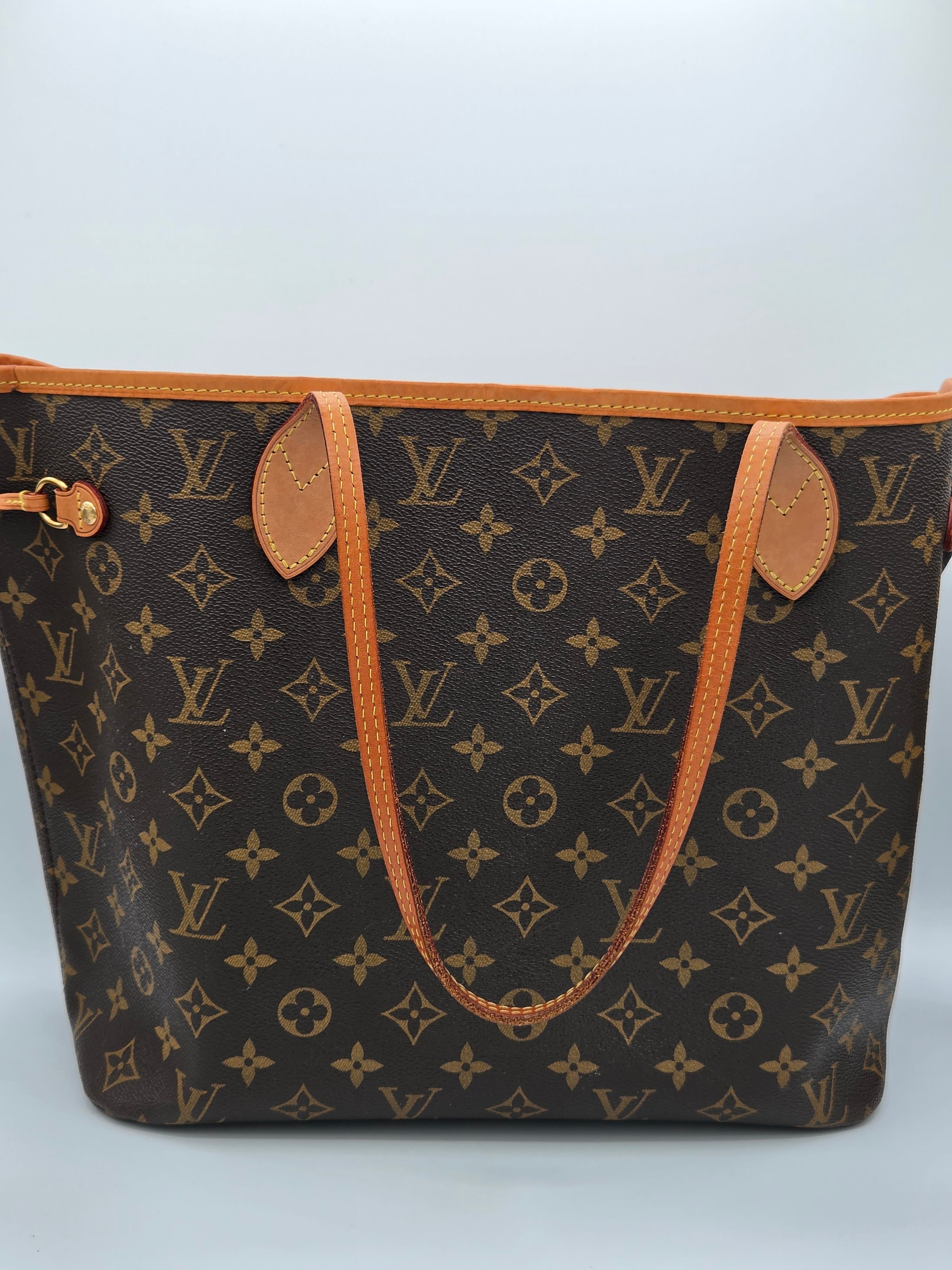 Designer handbag with monogram pattern on a light gray background