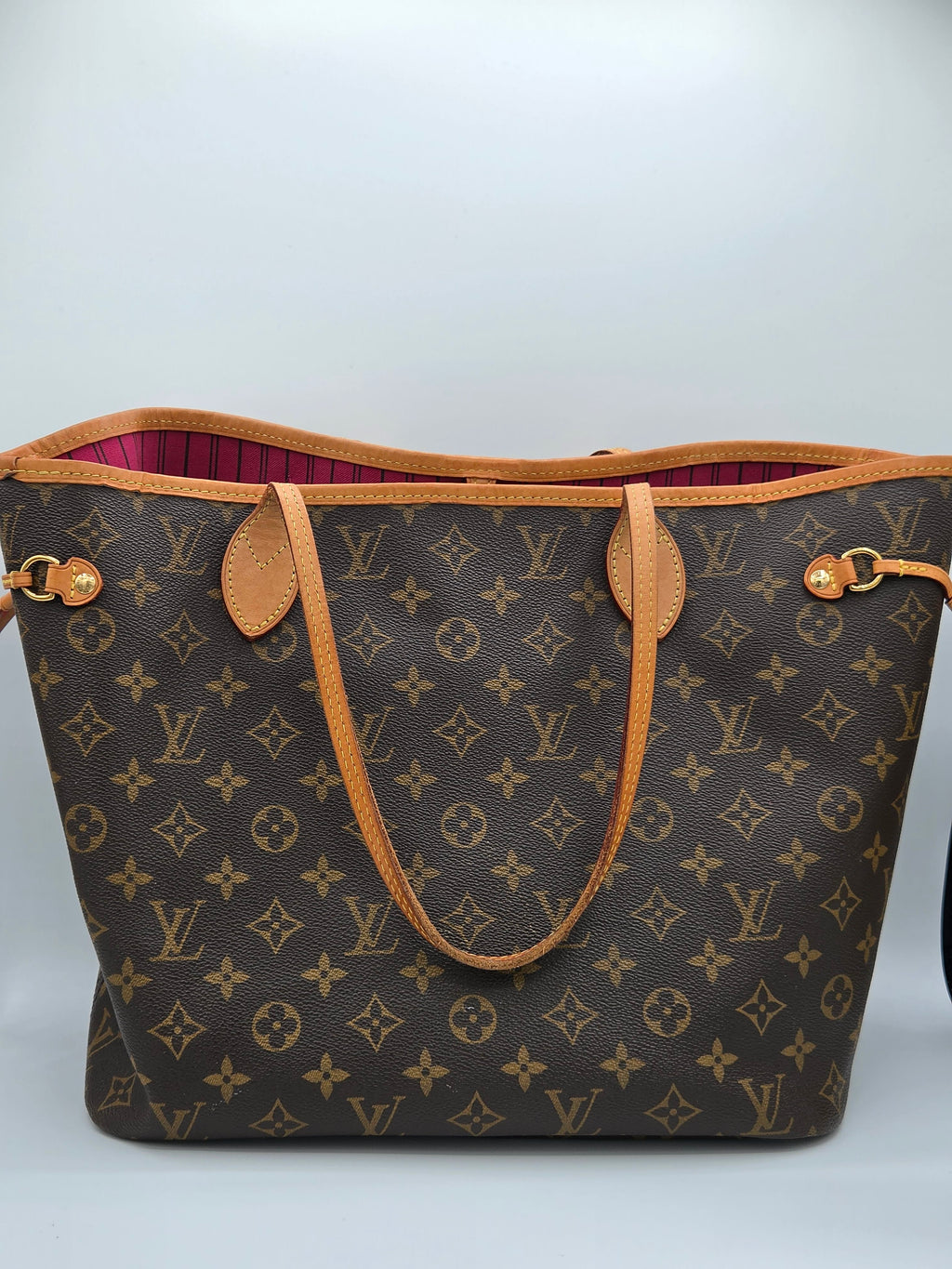 Designer handbag with monogram pattern on a white background