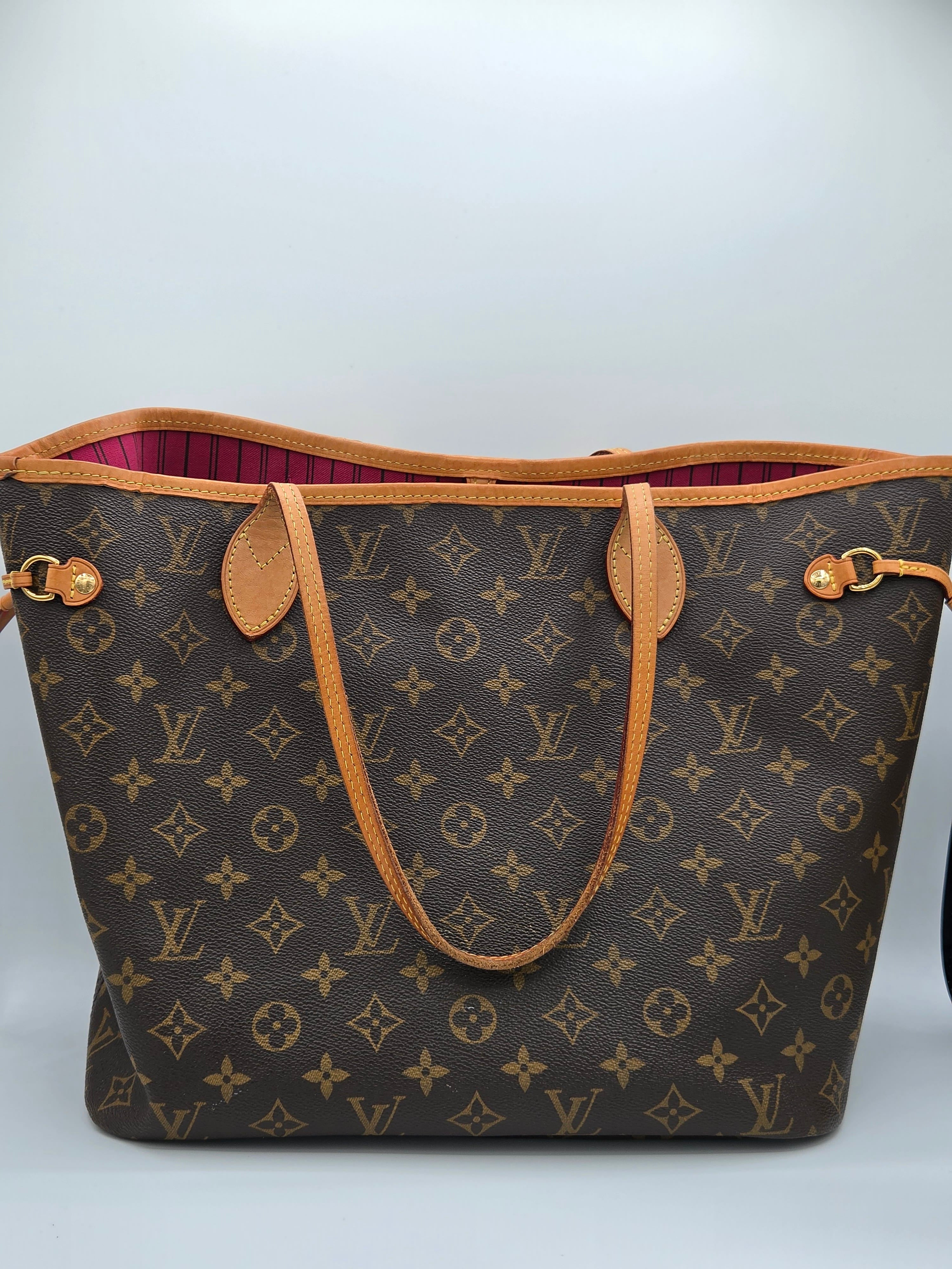 Designer handbag with monogram pattern on a white background