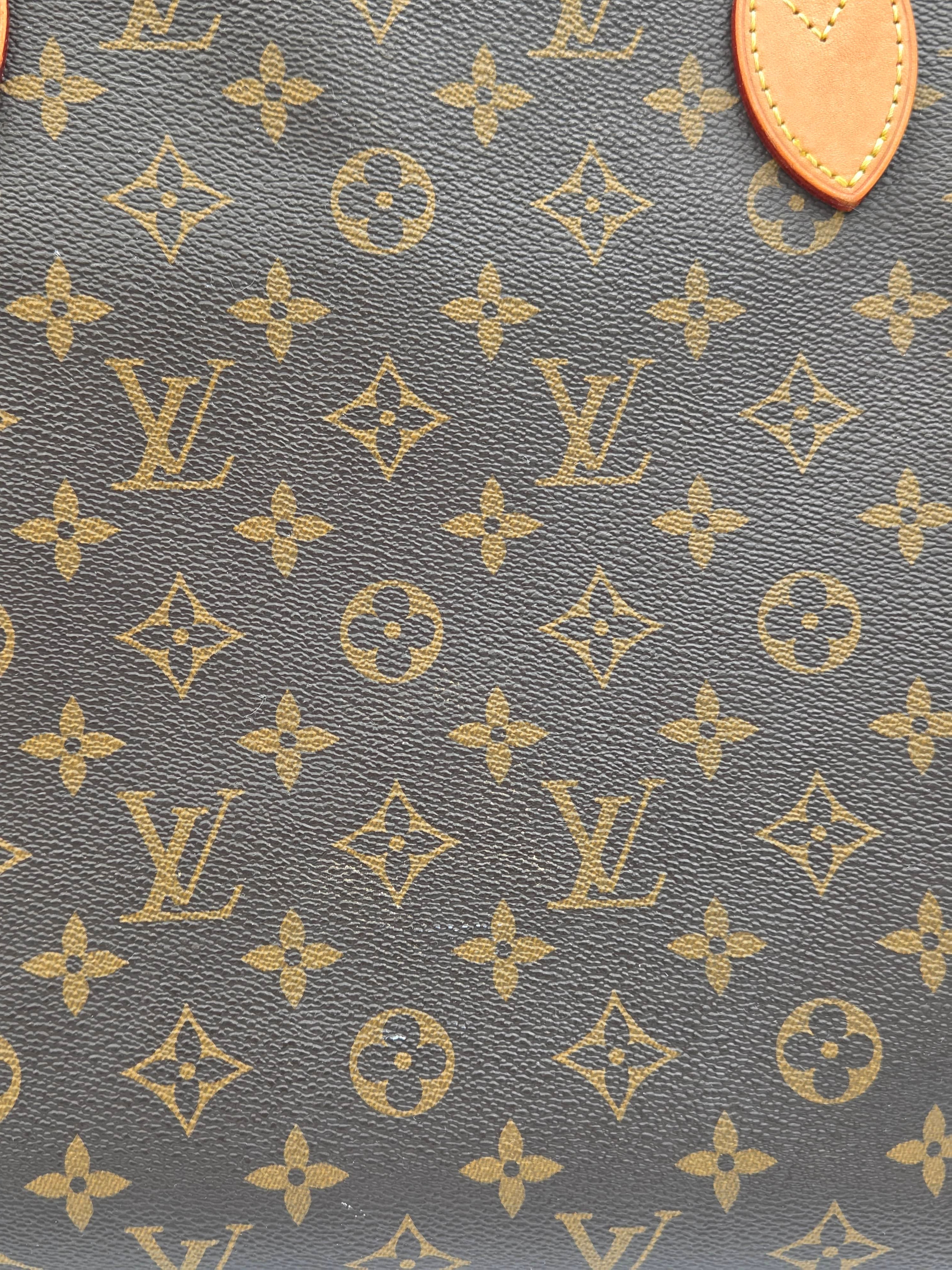 Close-up of a patterned fabric with a prominent brand logo on a gray background.