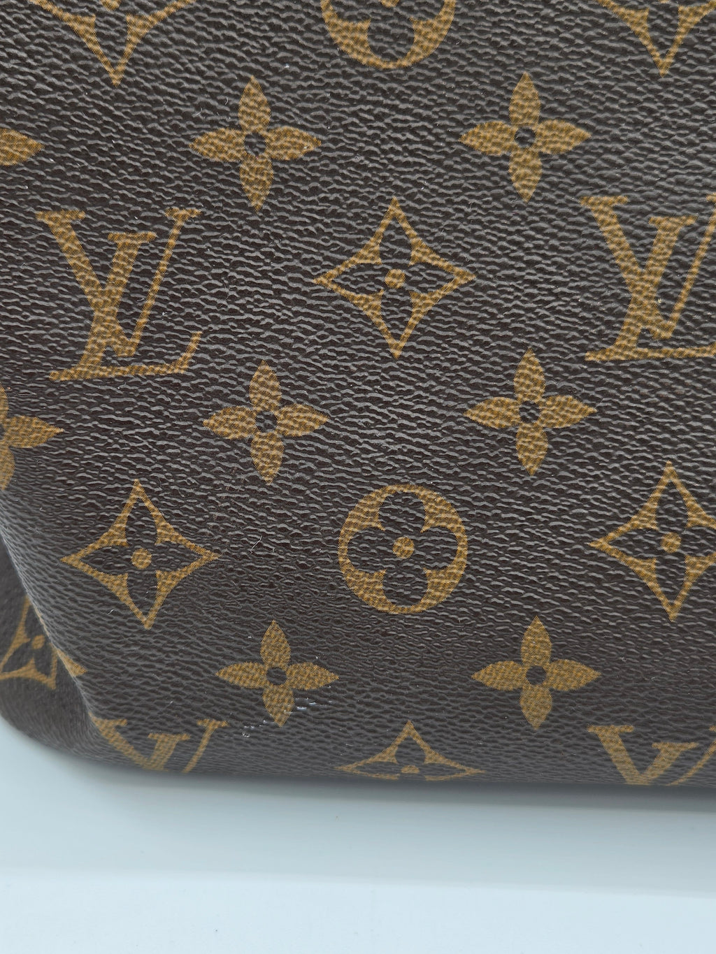 Close-up of a textured surface with a pattern resembling a famous brand logo.