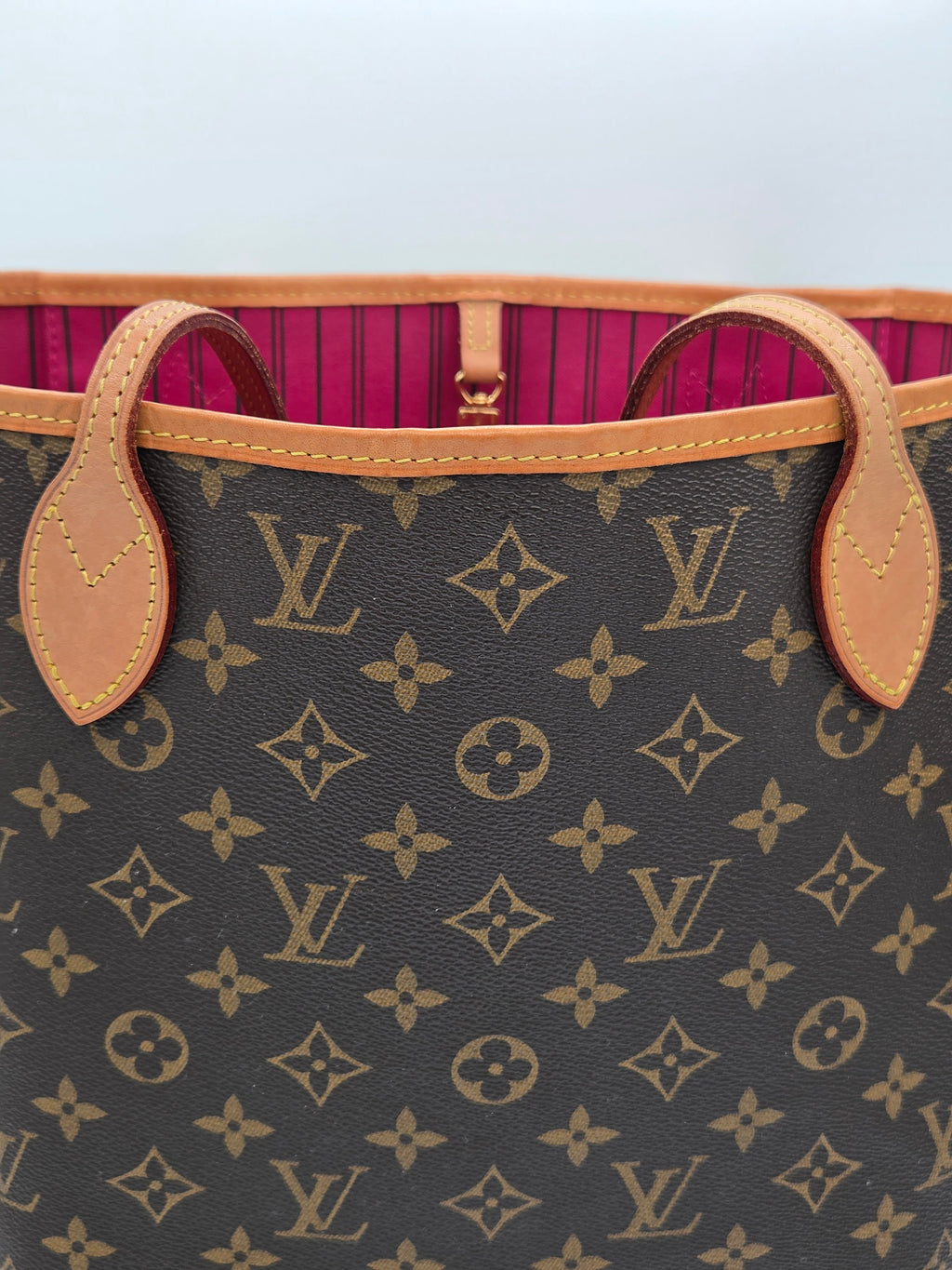 Louis Vuitton suitcase with monogram pattern and pink interior