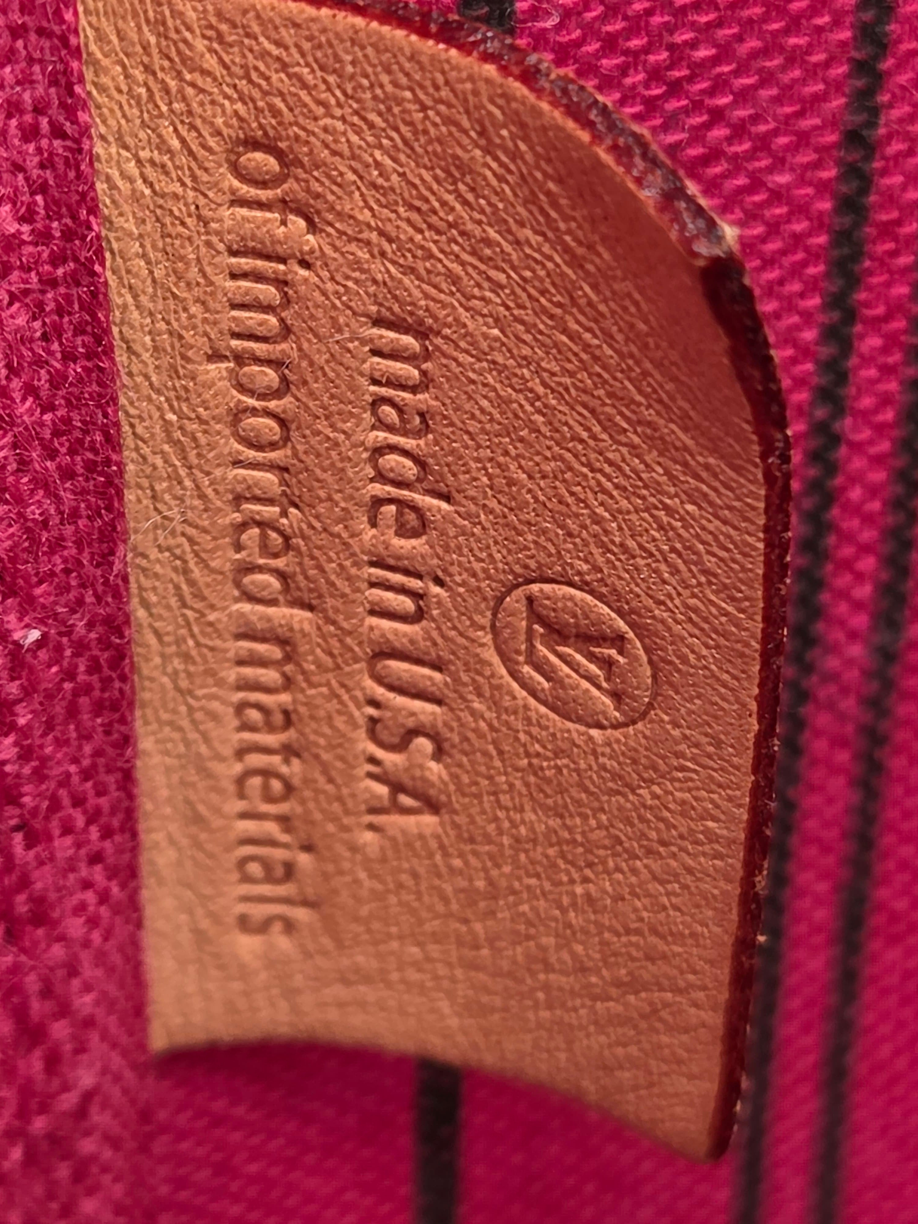 Leather label on a pink background indicating 'made in U.S.A. of imported materials'.