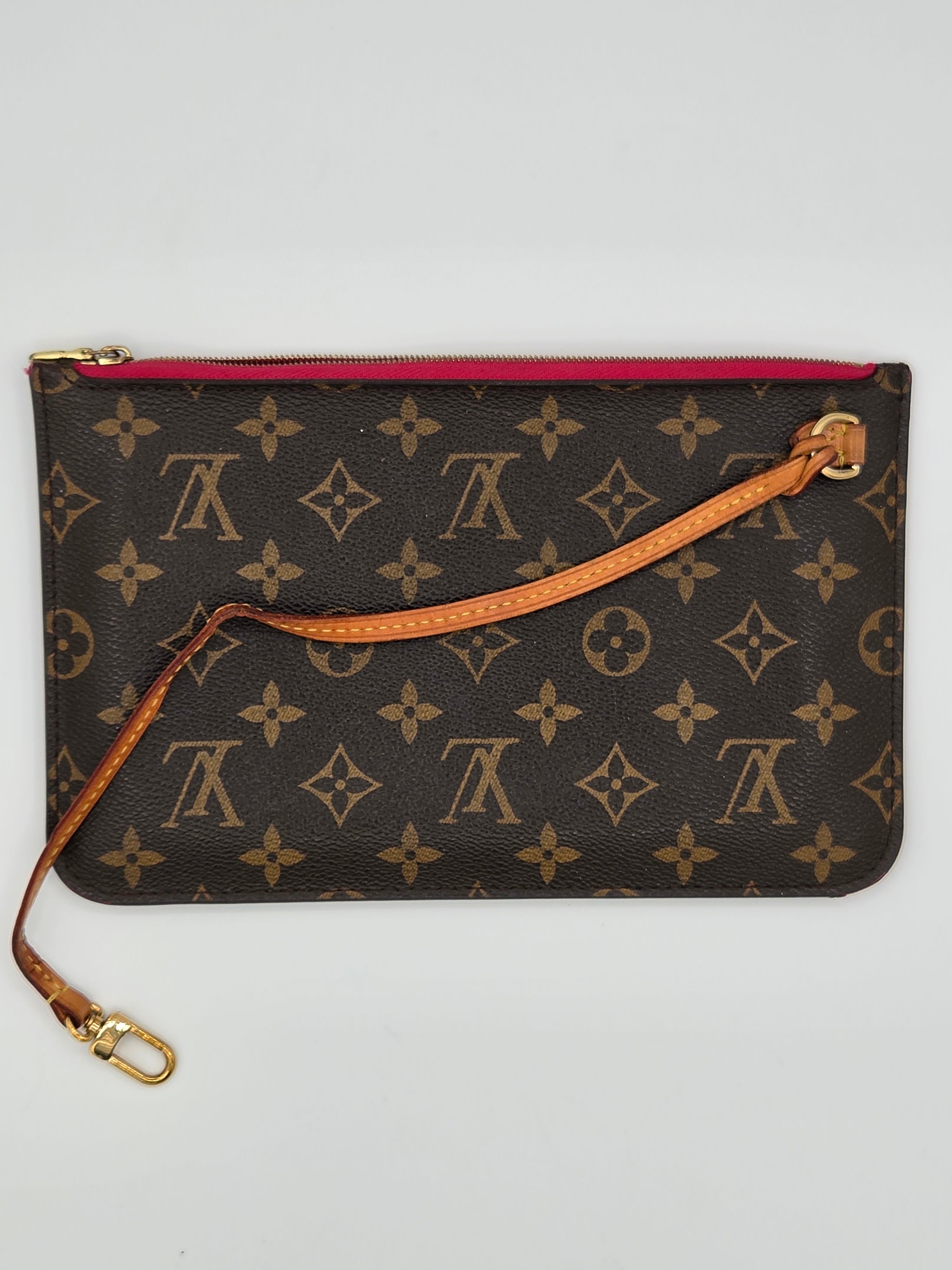 Designer handbag with monogram pattern on a light gray background