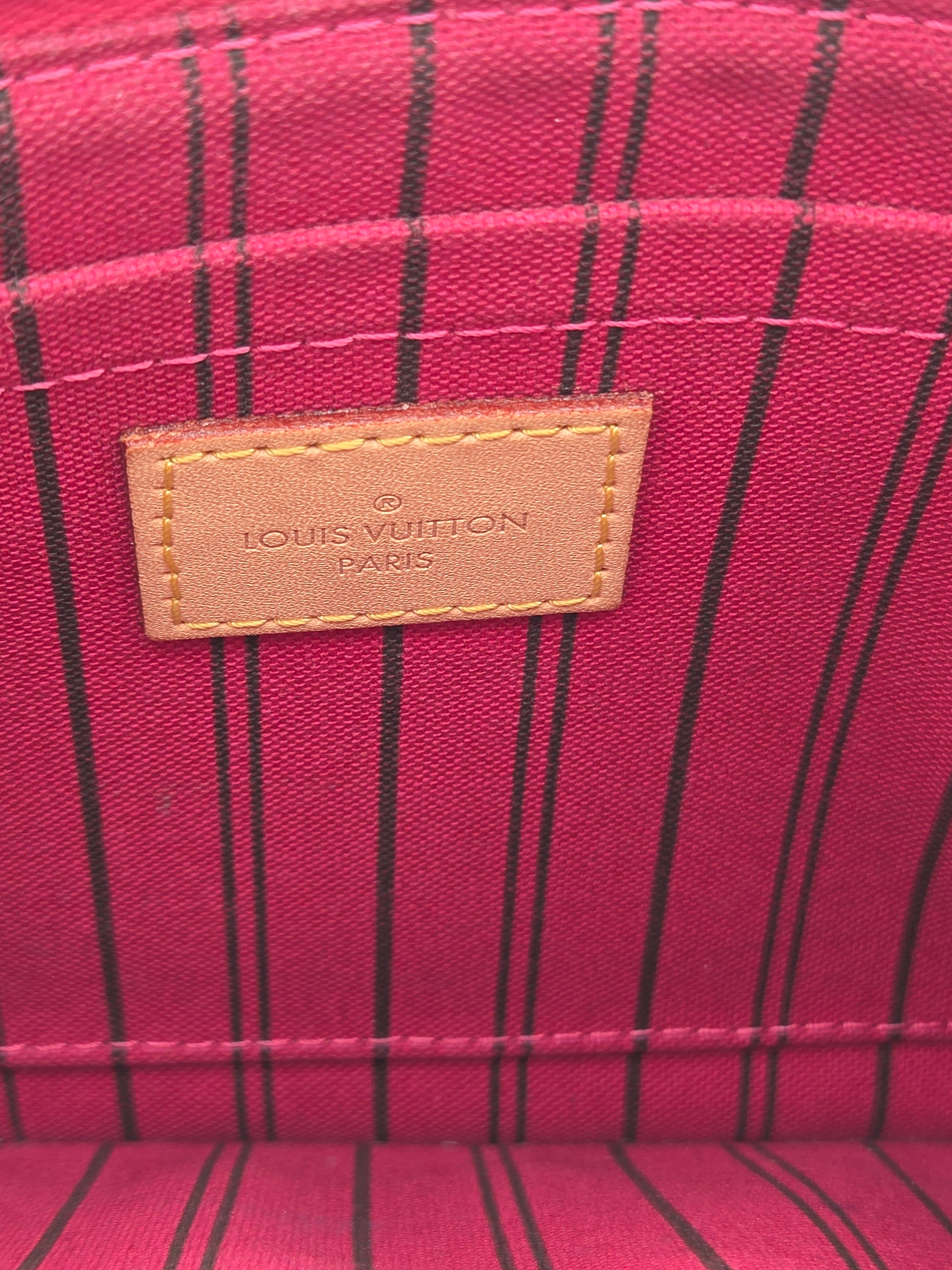 Close-up of a Louis Vuitton label on a red plaid fabric background