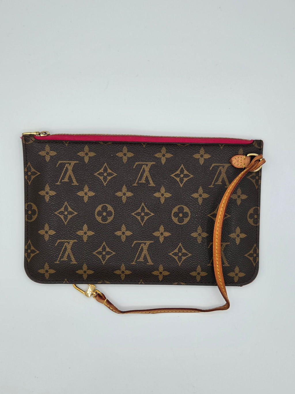 Designer handbag with monogram pattern on a light gray background