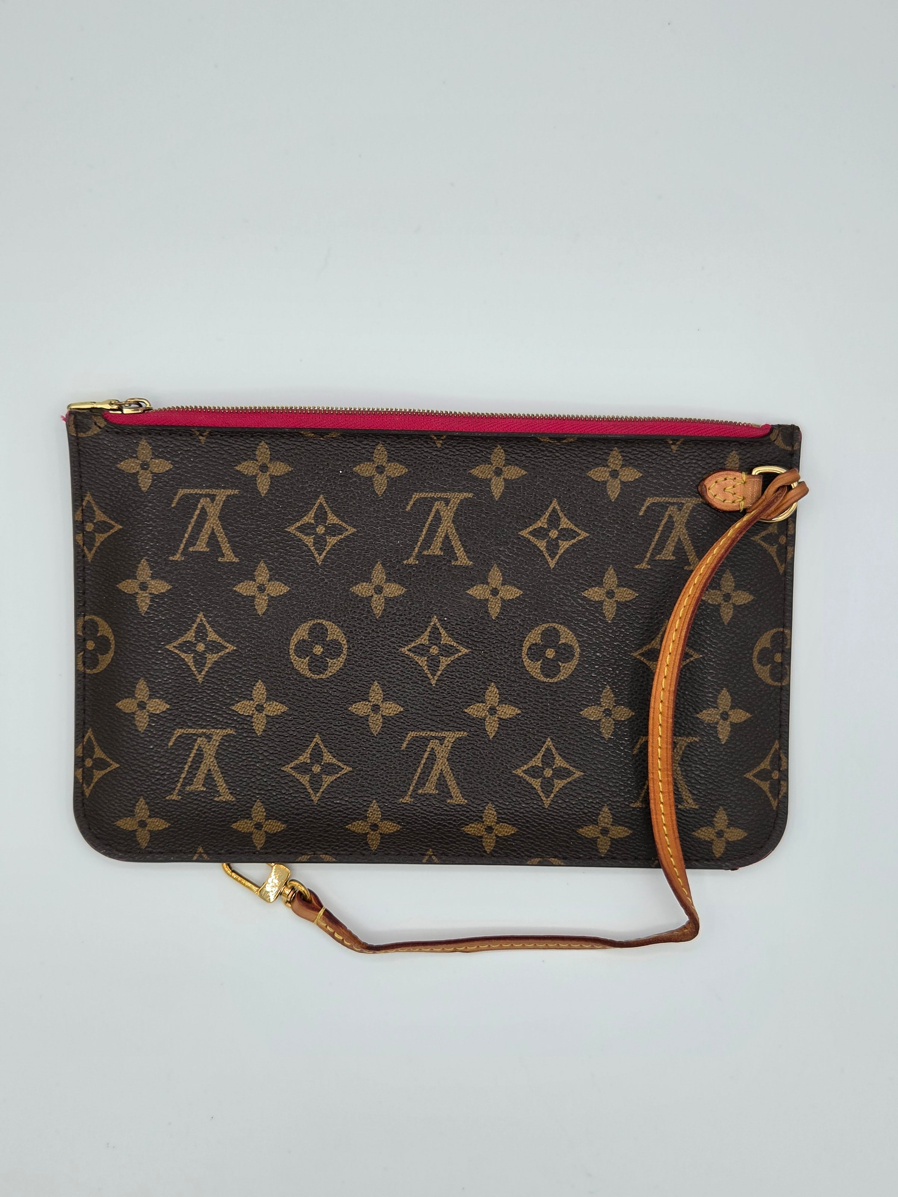 Designer handbag with monogram pattern on a light gray background