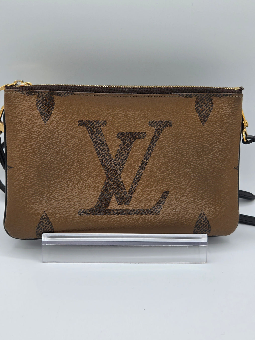 Brown leather pouch with brand logo on a white background
