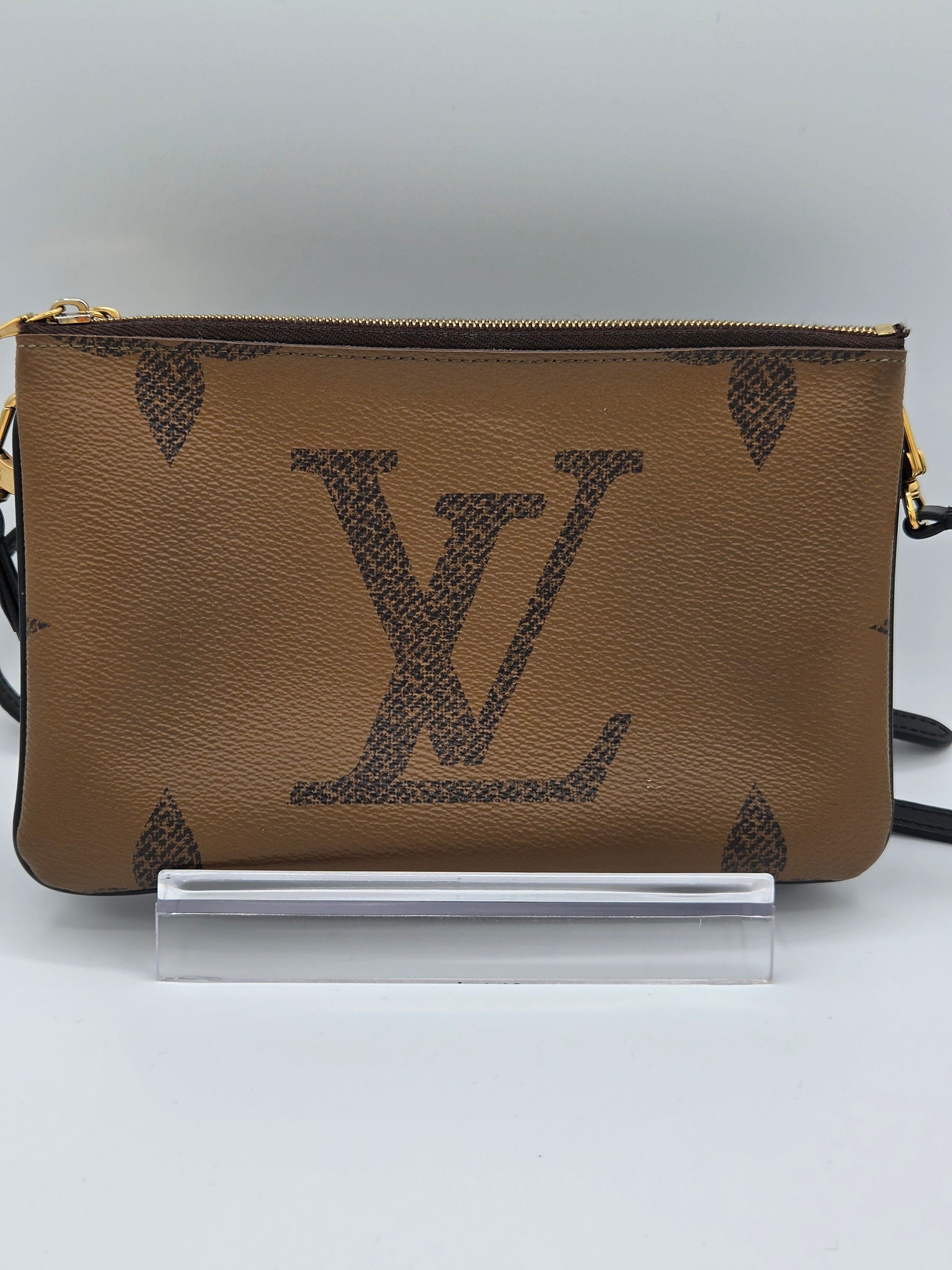 Brown leather pouch with brand logo on a white background