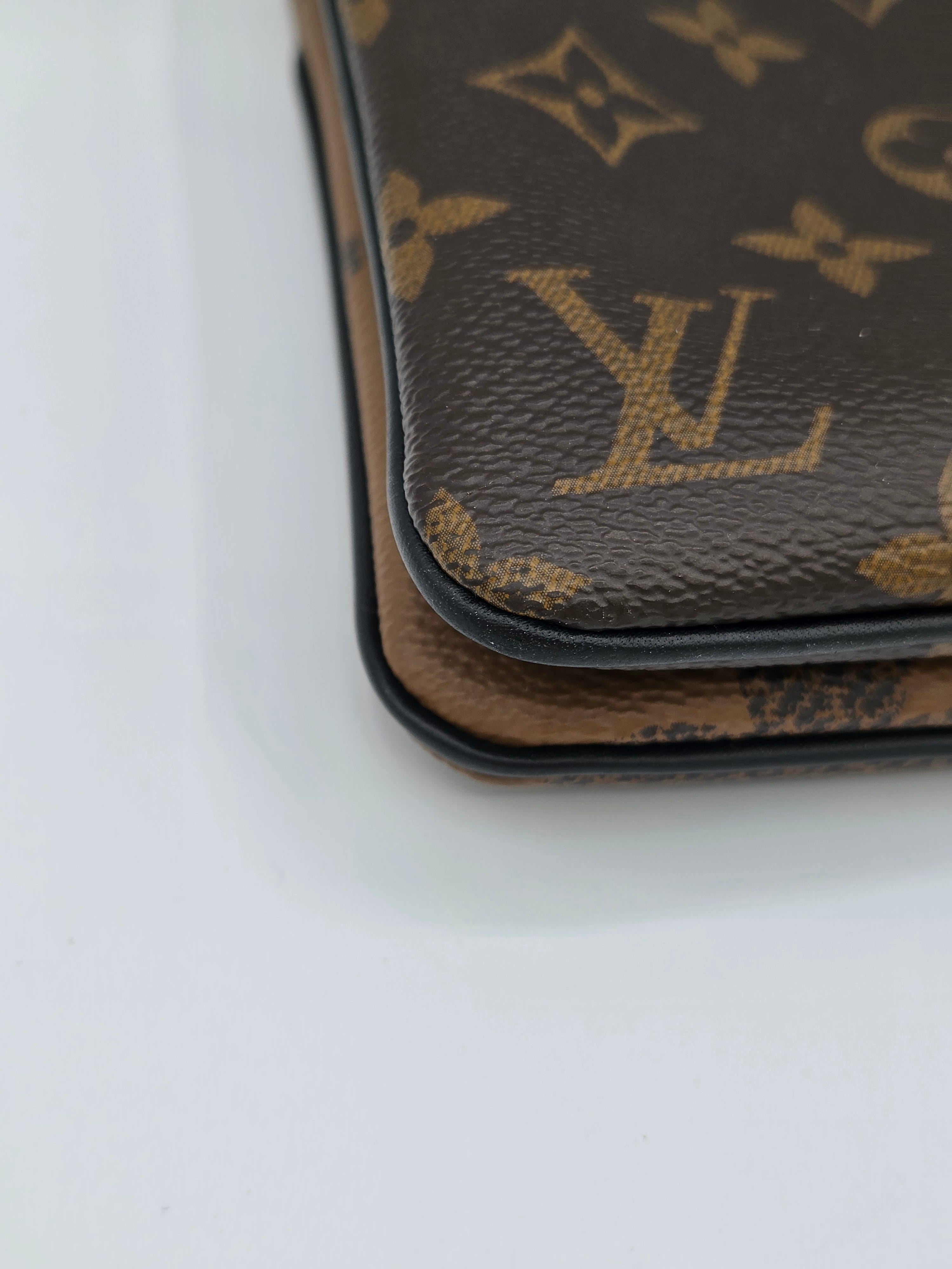 Close-up of a brown leather wallet with a pattern on a white background