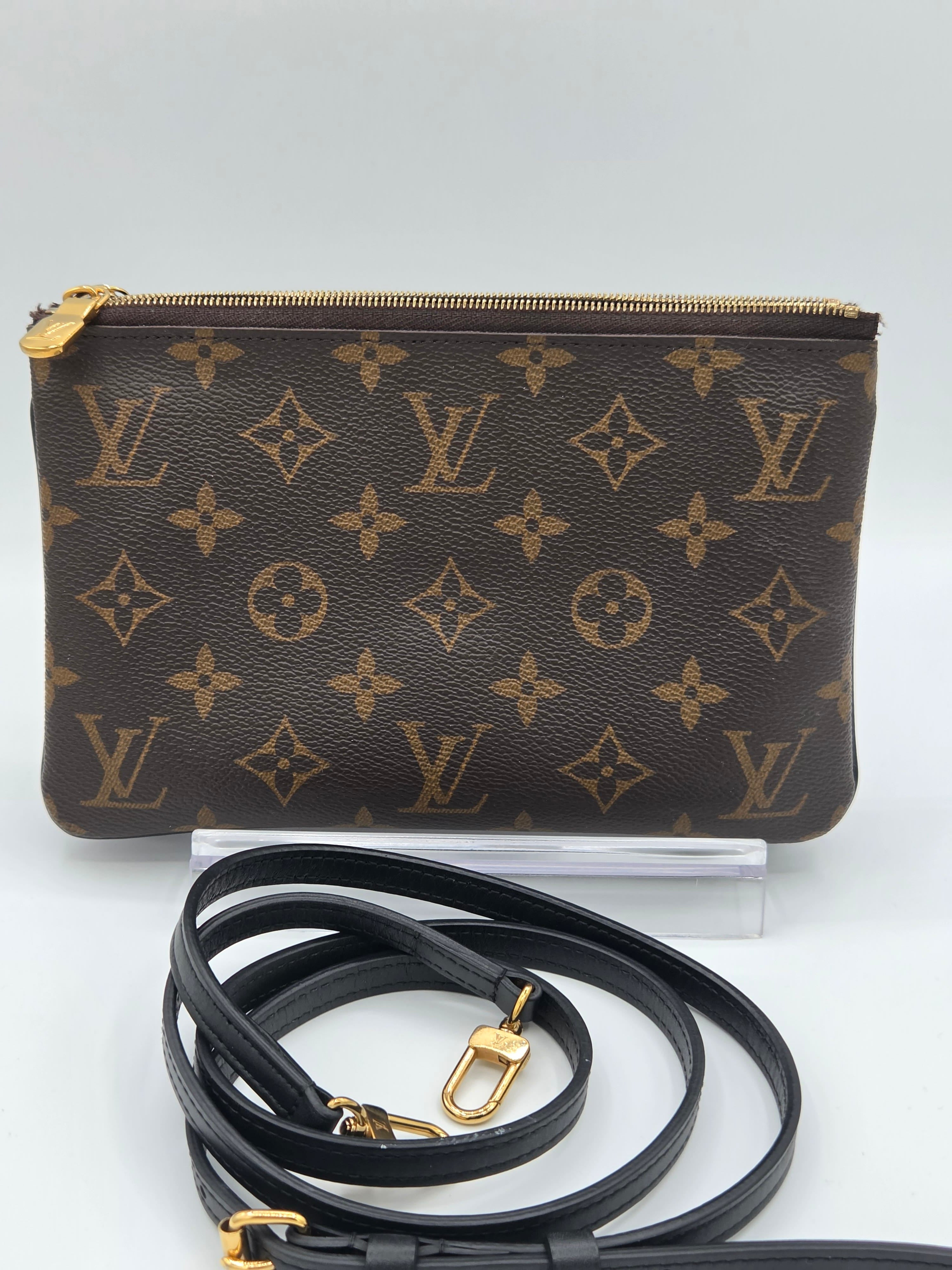 Louis Vuitton monogram clutch bag with a strap on a white background