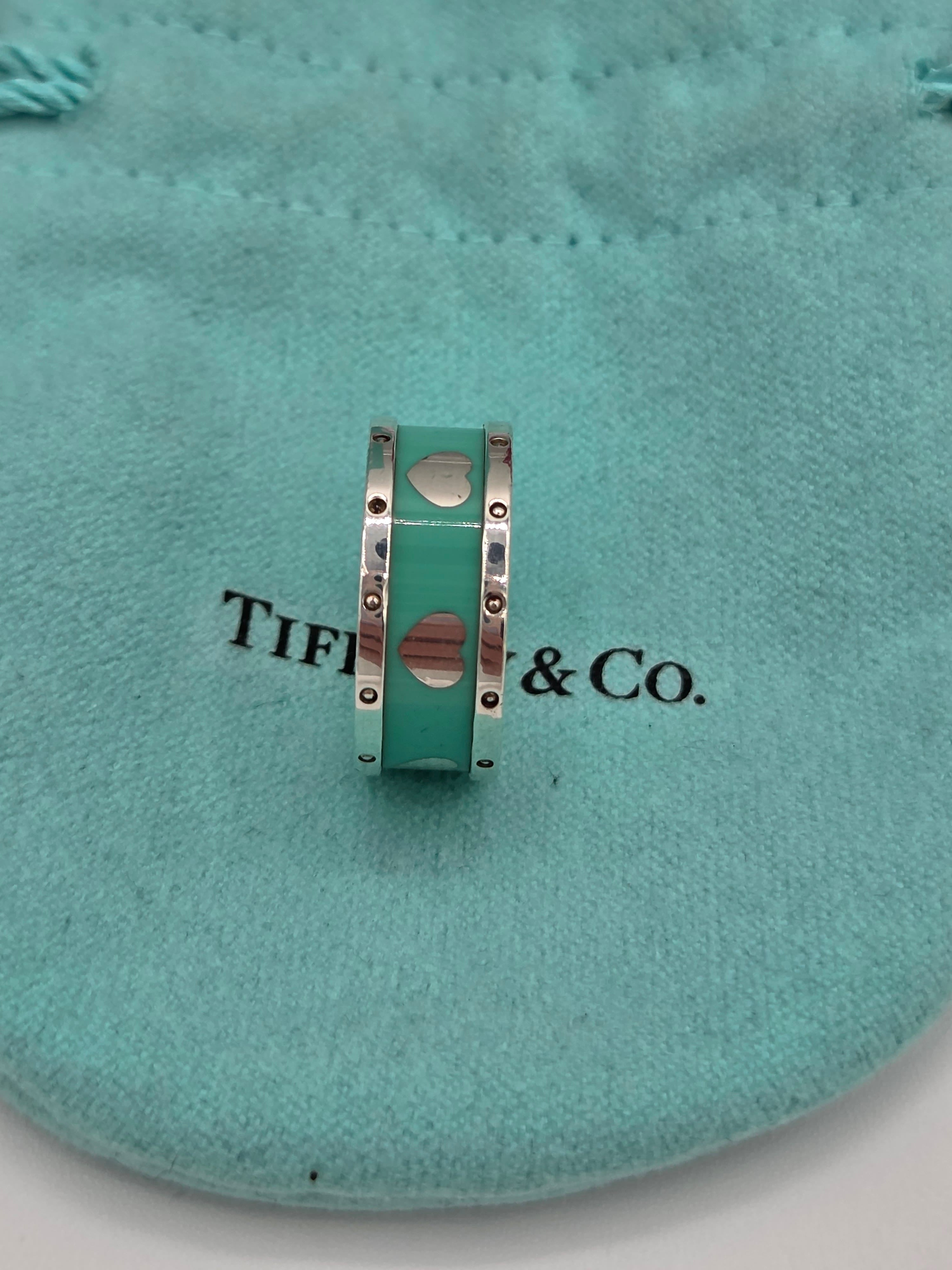 Tiffany & Co. bracelet with heart charms on a teal cushion