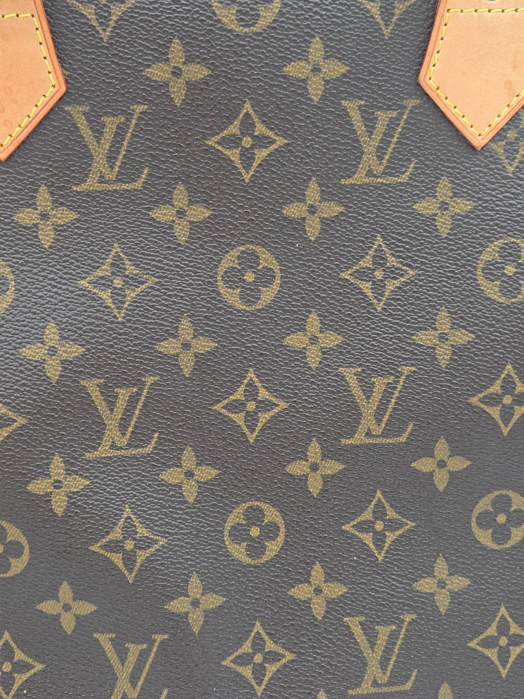 Close-up of a patterned fabric with brand logo and geometric design.