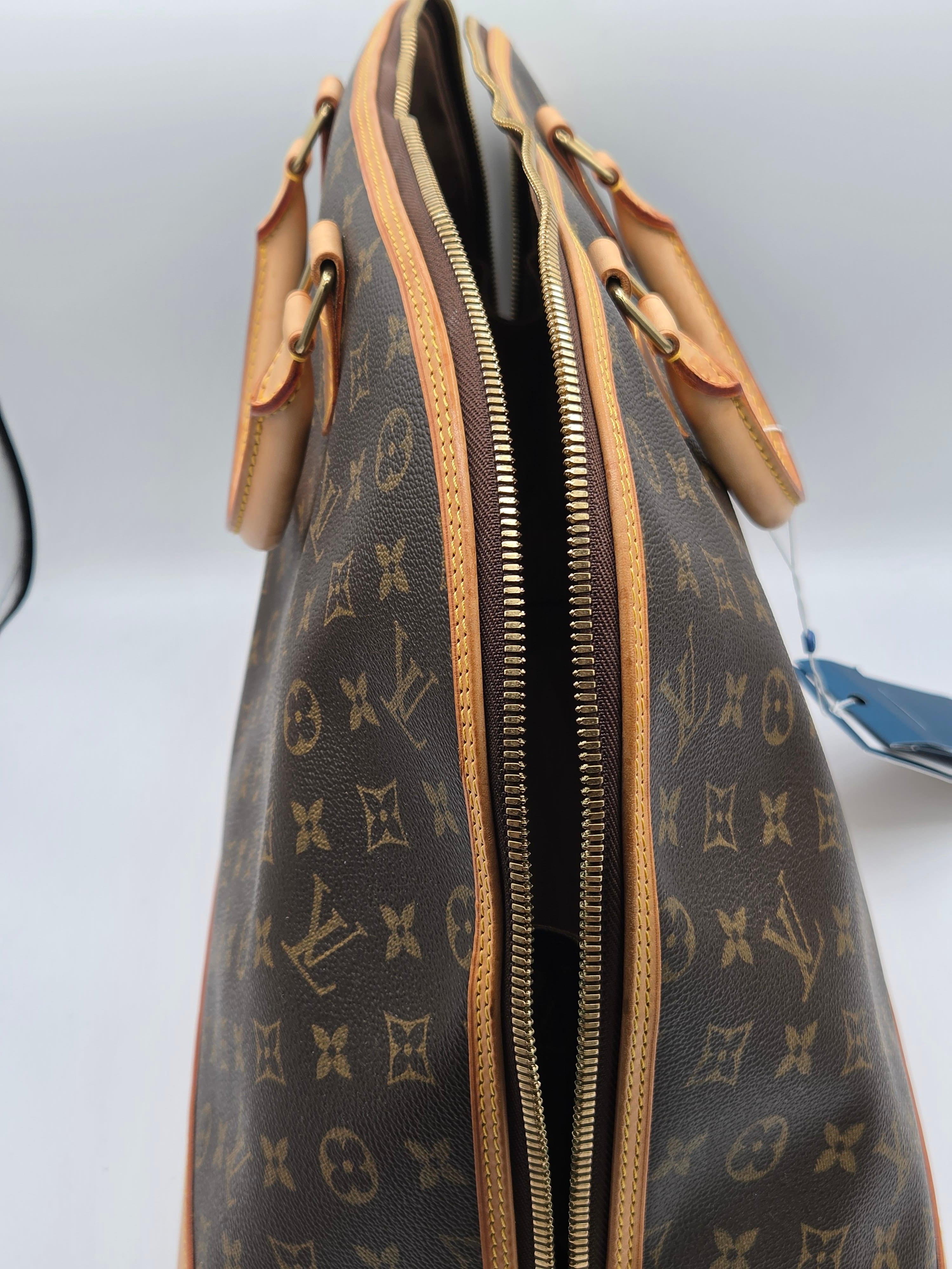 Designer handbag with monogram pattern on a light gray background