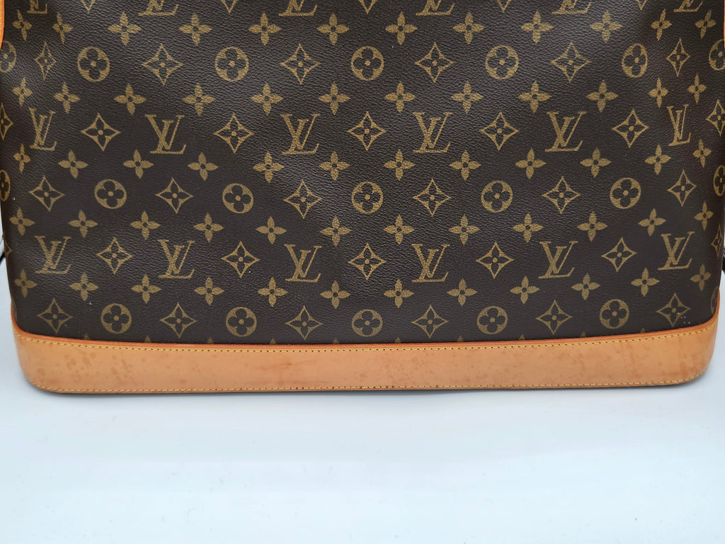 Brown leather bag with brand logo pattern on a white background