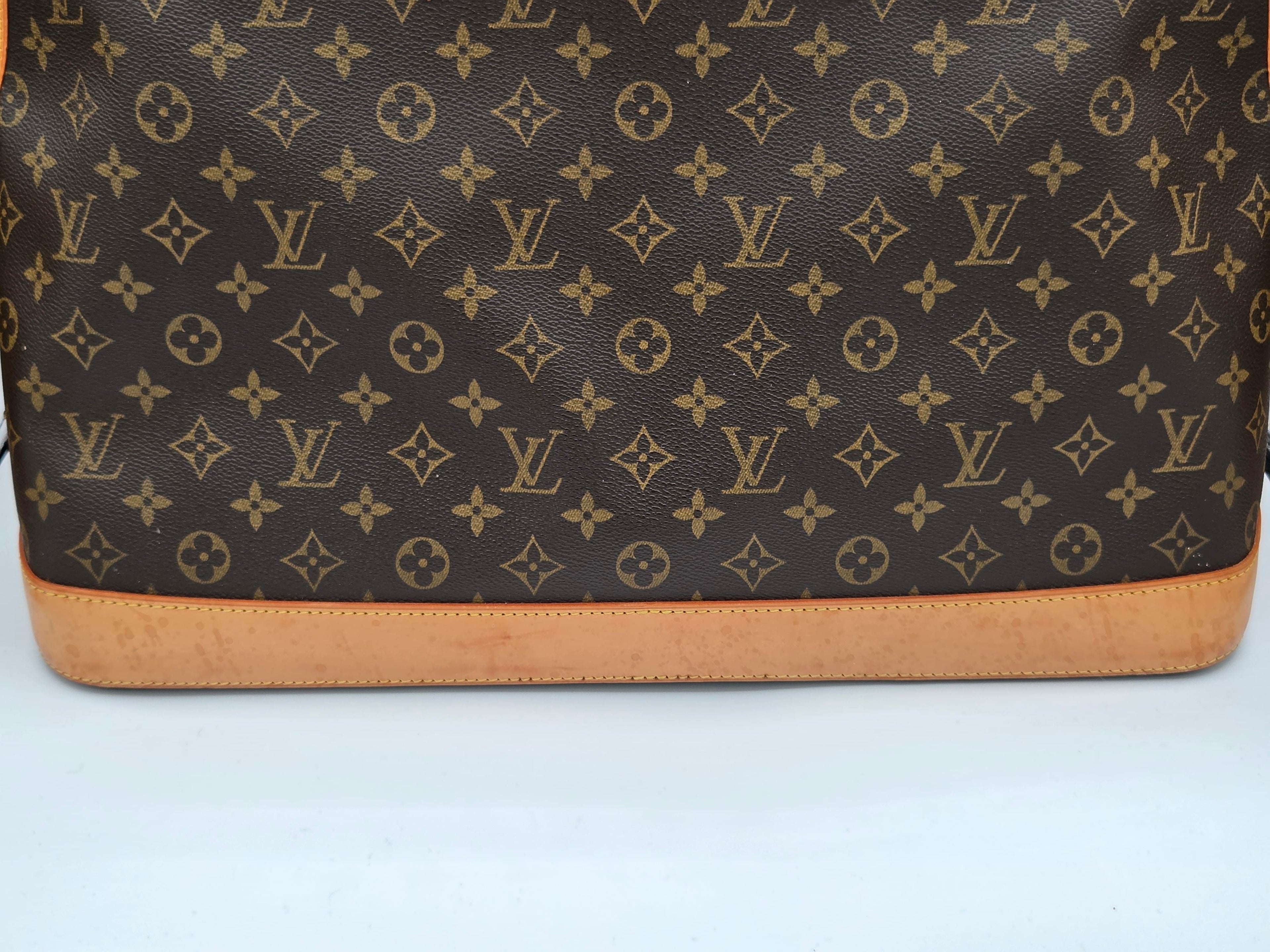 Brown leather bag with brand logo pattern on a white background