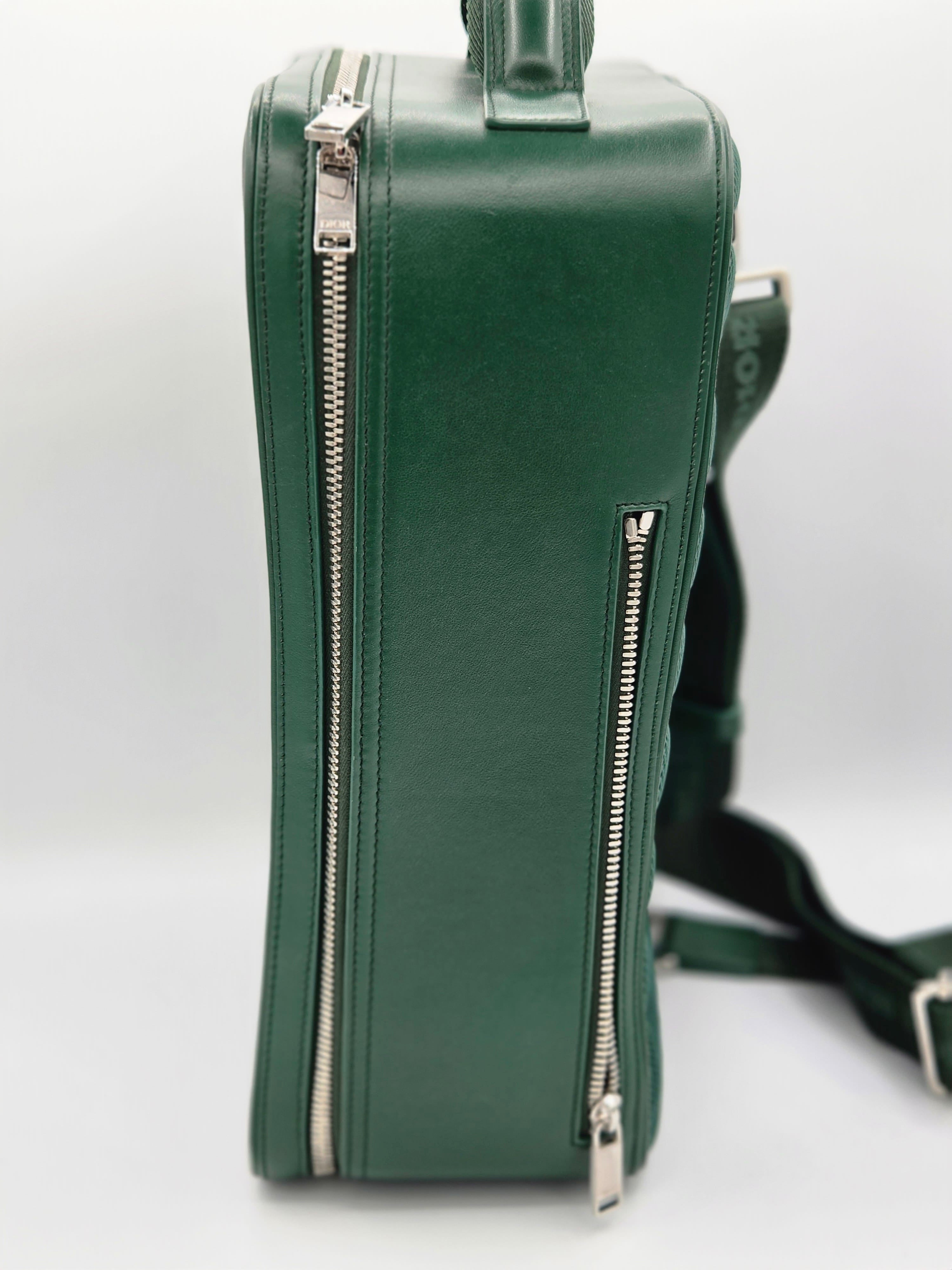 Green leather bag with zippers on a white background