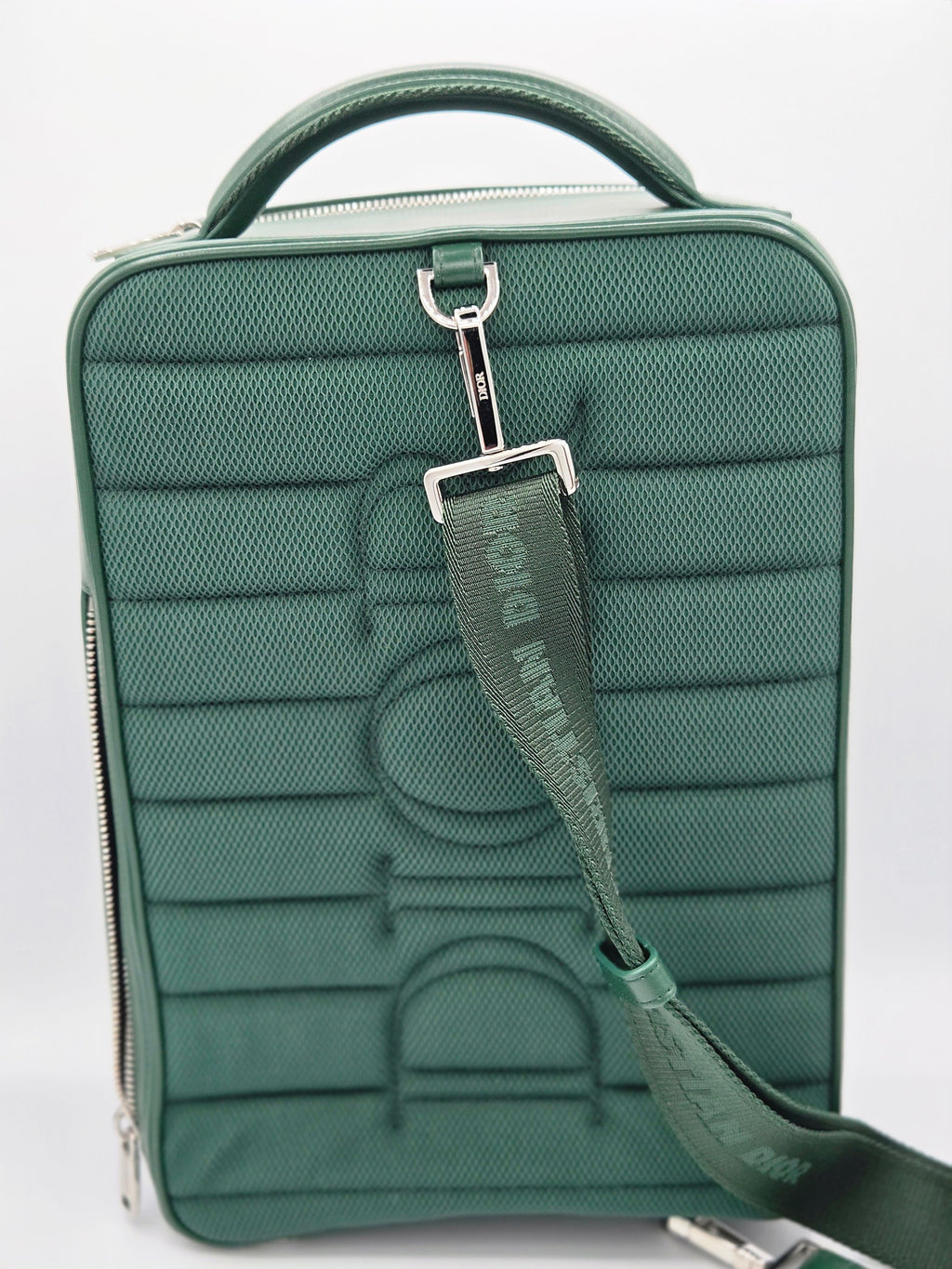 Green textured bag with a visible brand logo on a white background