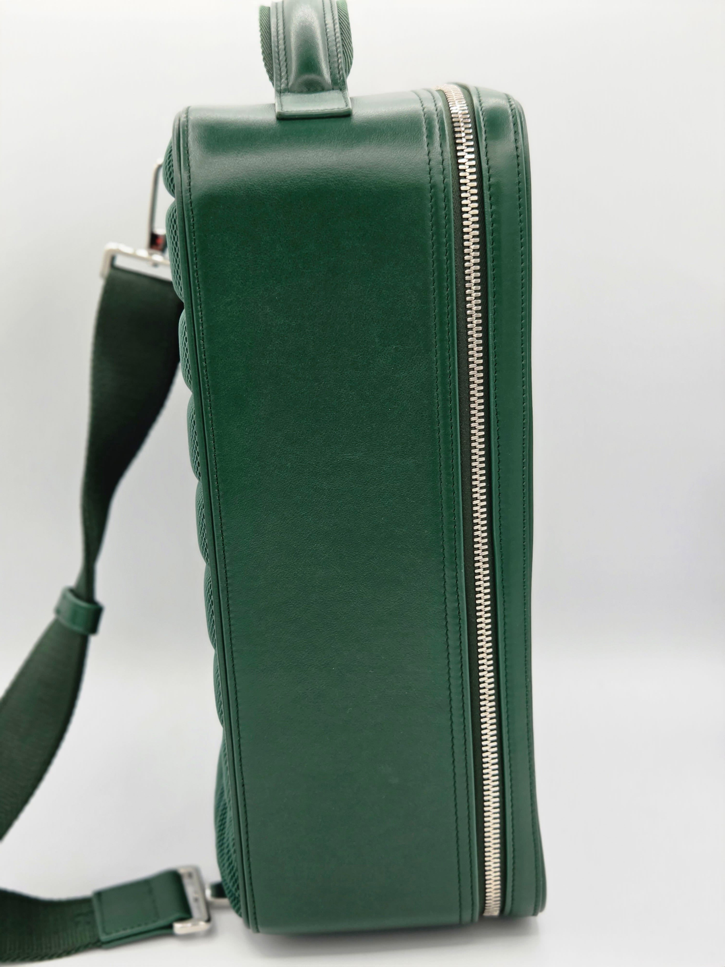 Green handbag with a strap on a light gray background