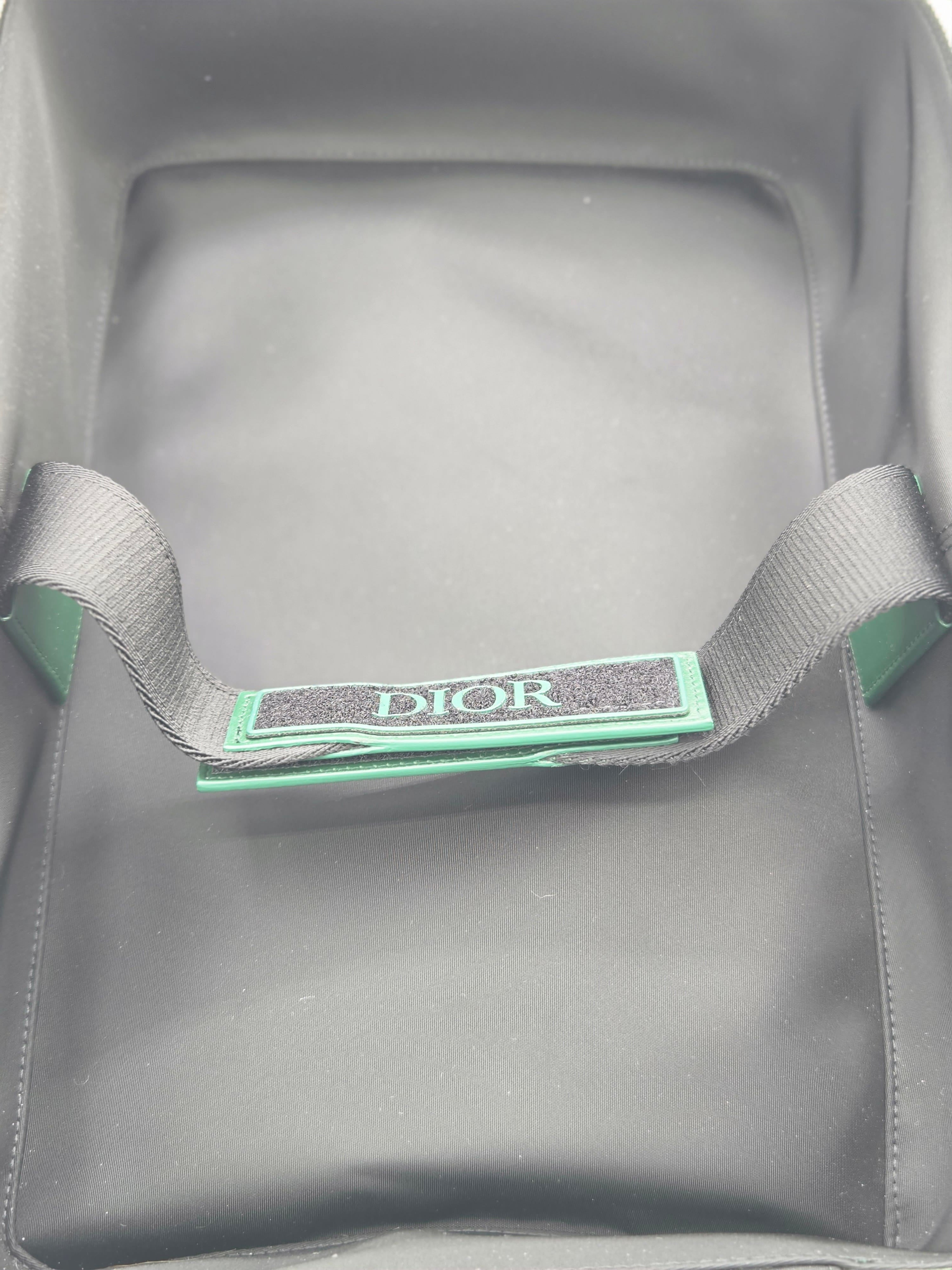 Gray bag with a green Dior tag