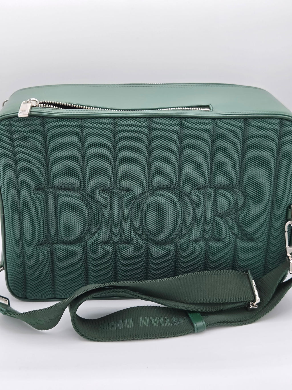Green bag with 'Dior' branding on a white background