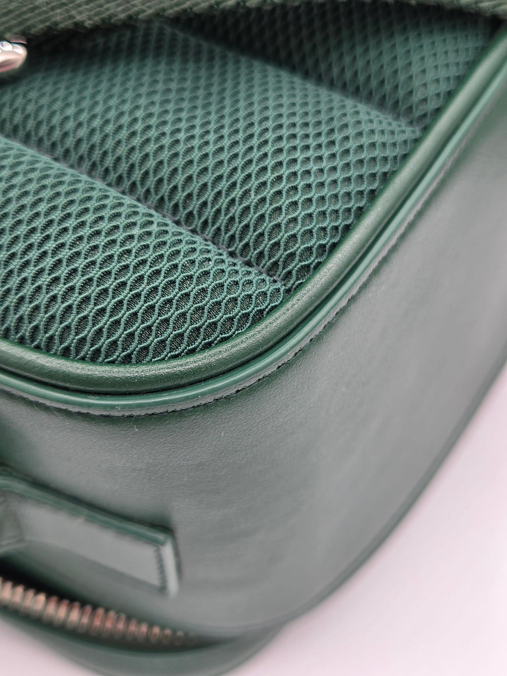 Close-up of a green car seat with mesh design