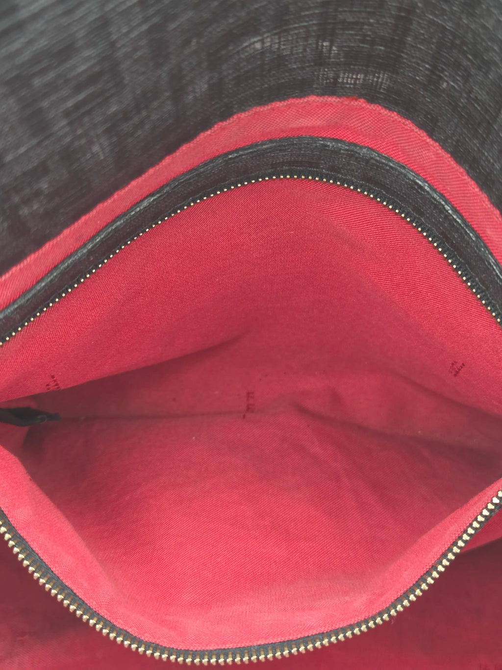 Close-up of a red fabric with a zipper, showing texture and color details.