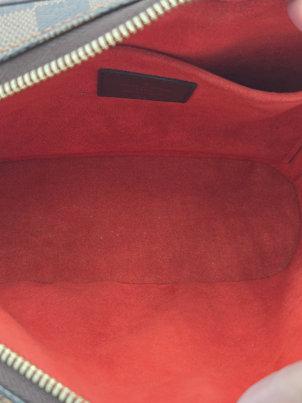 Close-up of a red textured surface with a zipper