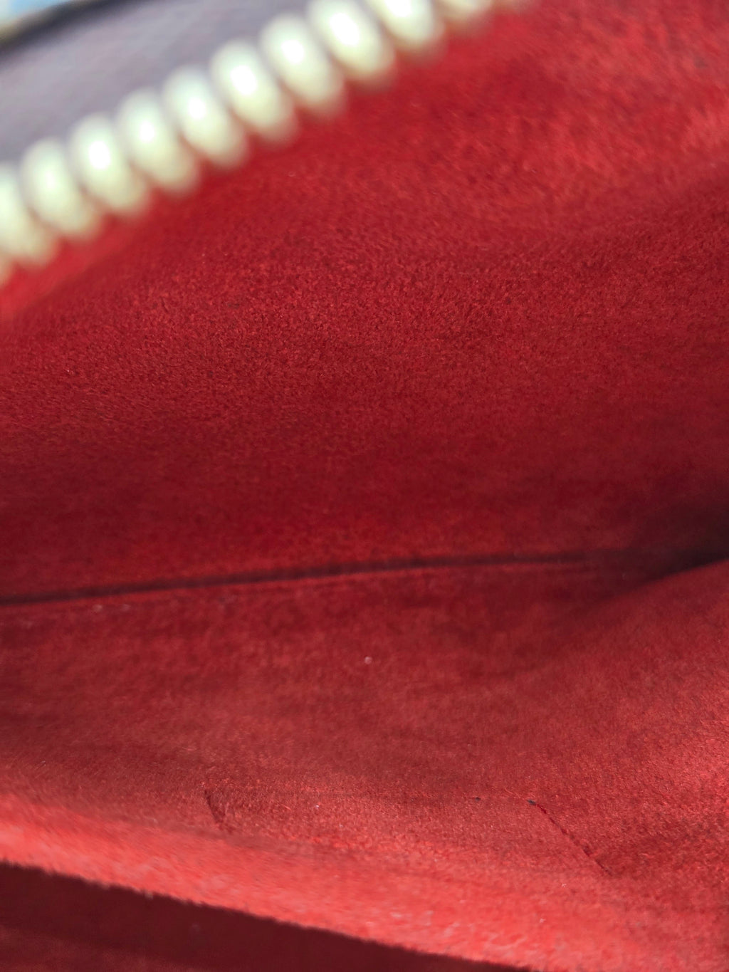 Close-up of a red textured fabric with a zipper