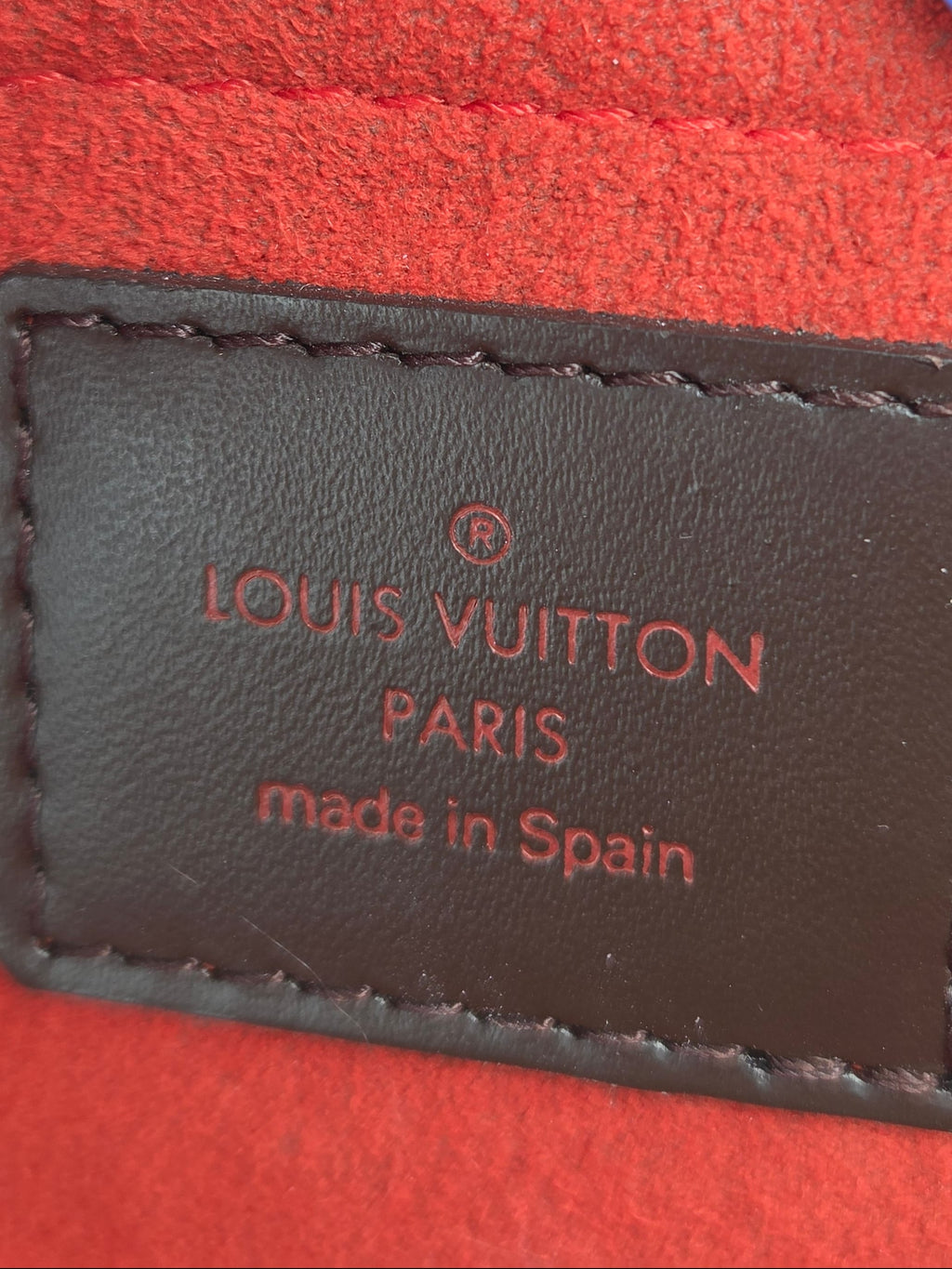 Louis Vuitton label on a red textured surface