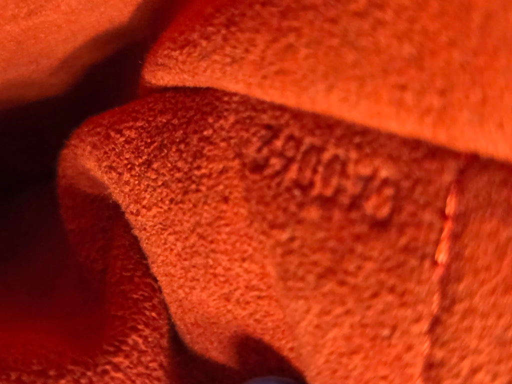 Close-up of a textured red surface with embossed text.