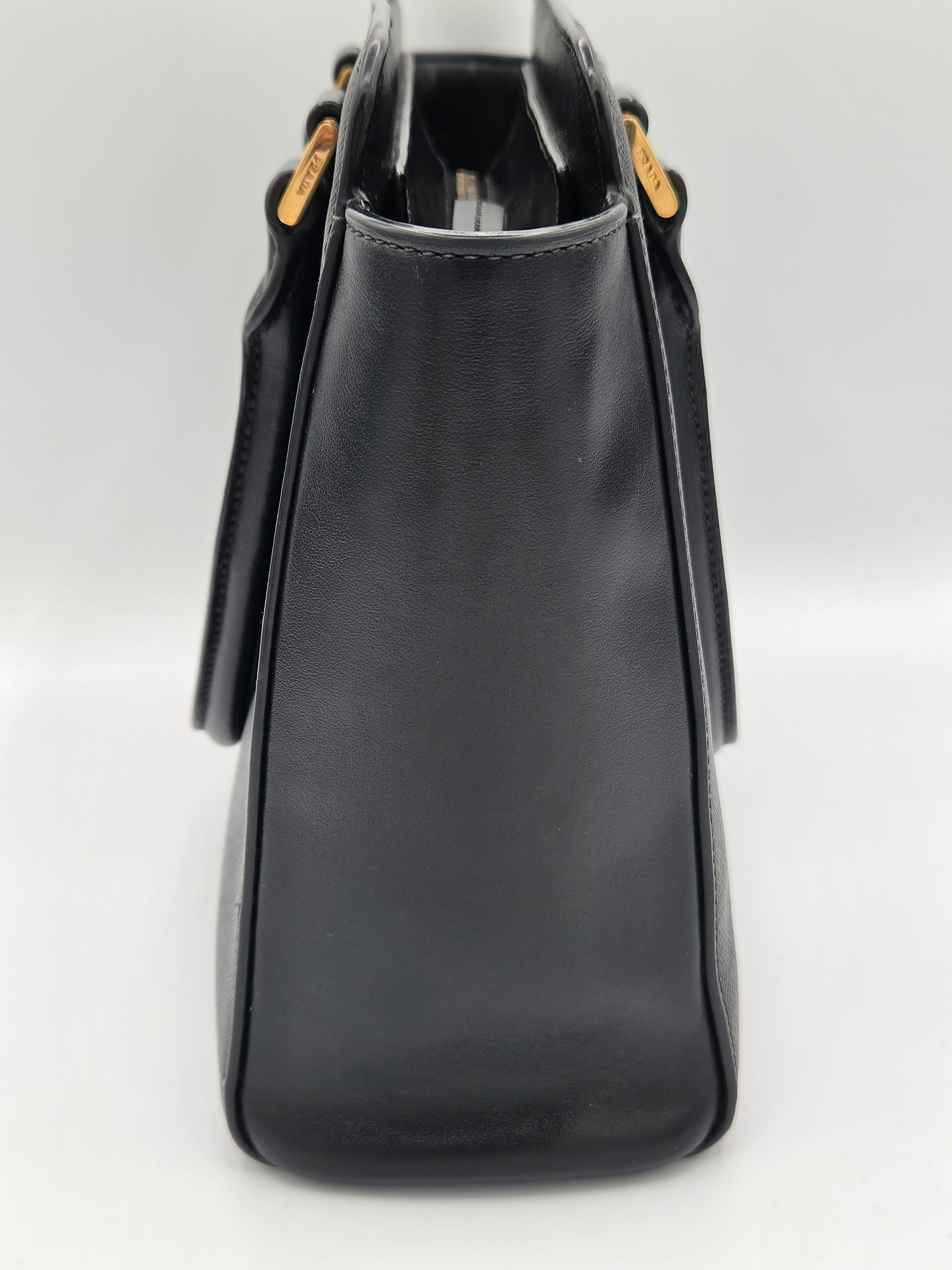 Black handbag on a light gray background