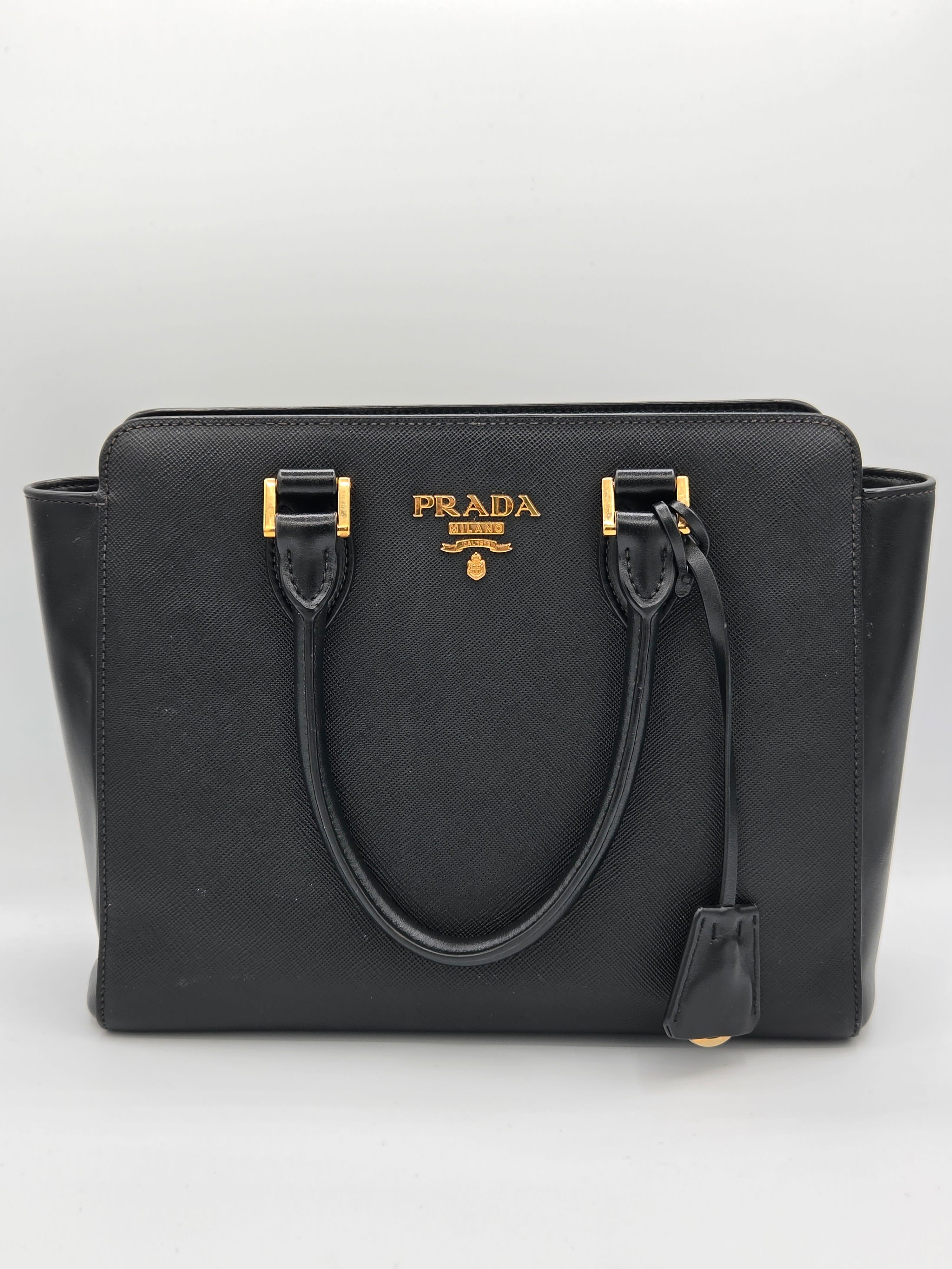 Black Prada handbag on a light gray background