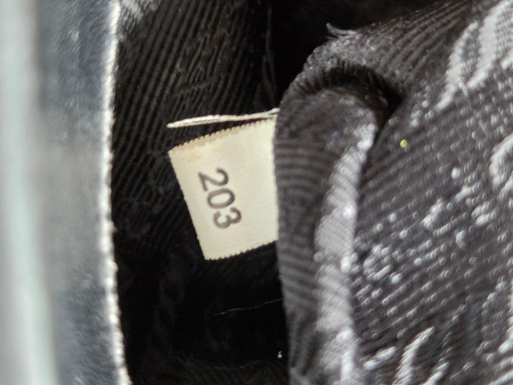 Close-up of a textured fabric with a visible label number 203.