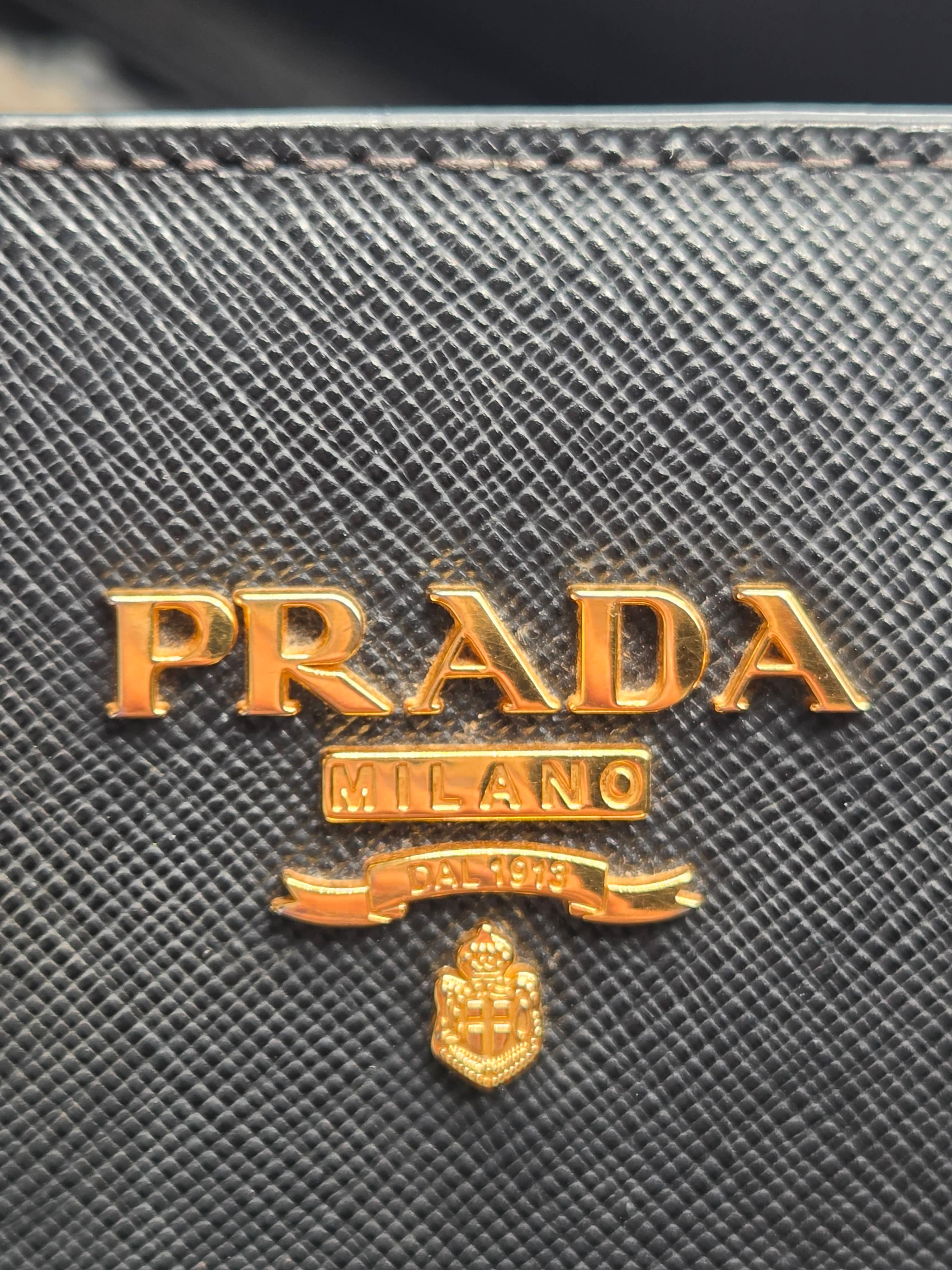 Close-up of Prada logo on a textured surface