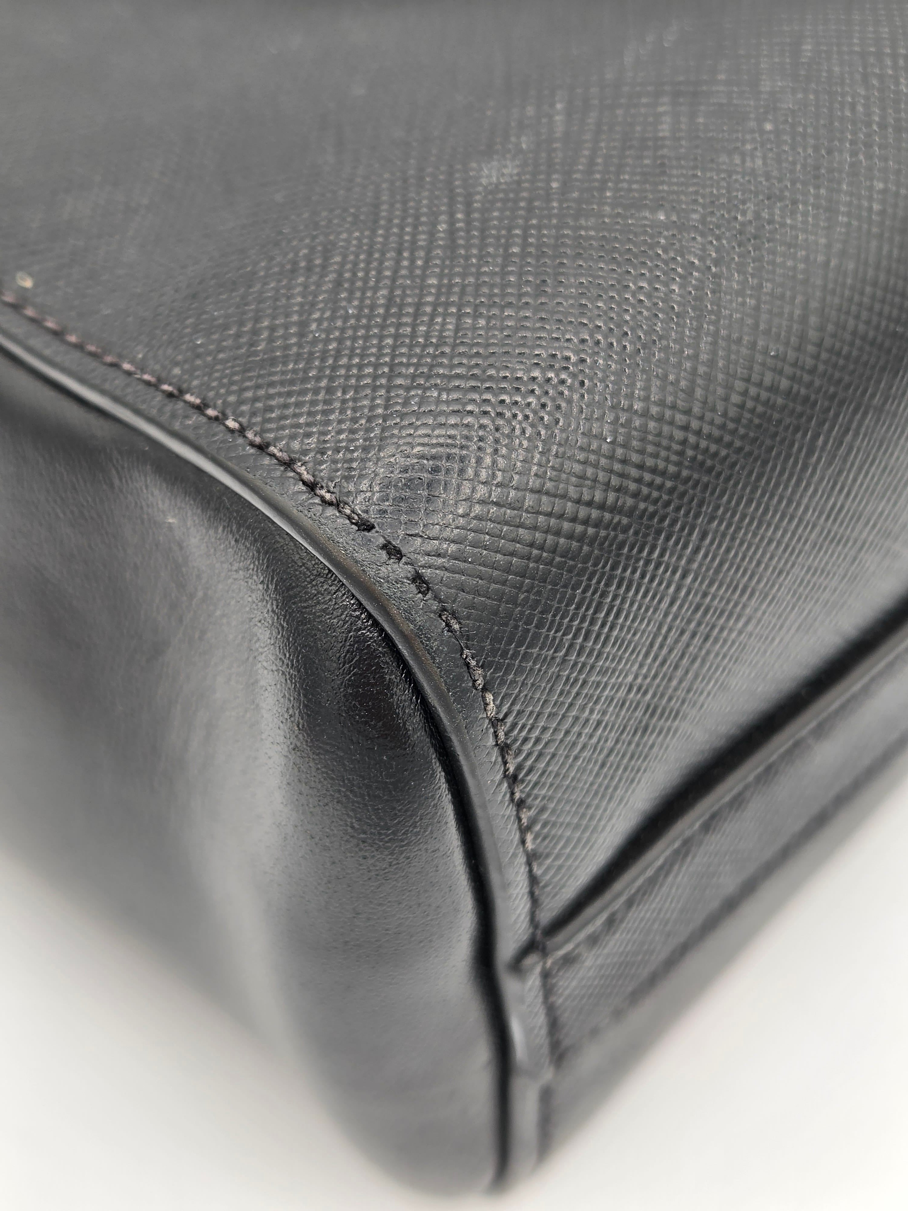 Close-up of a textured gray fabric surface with stitching details.