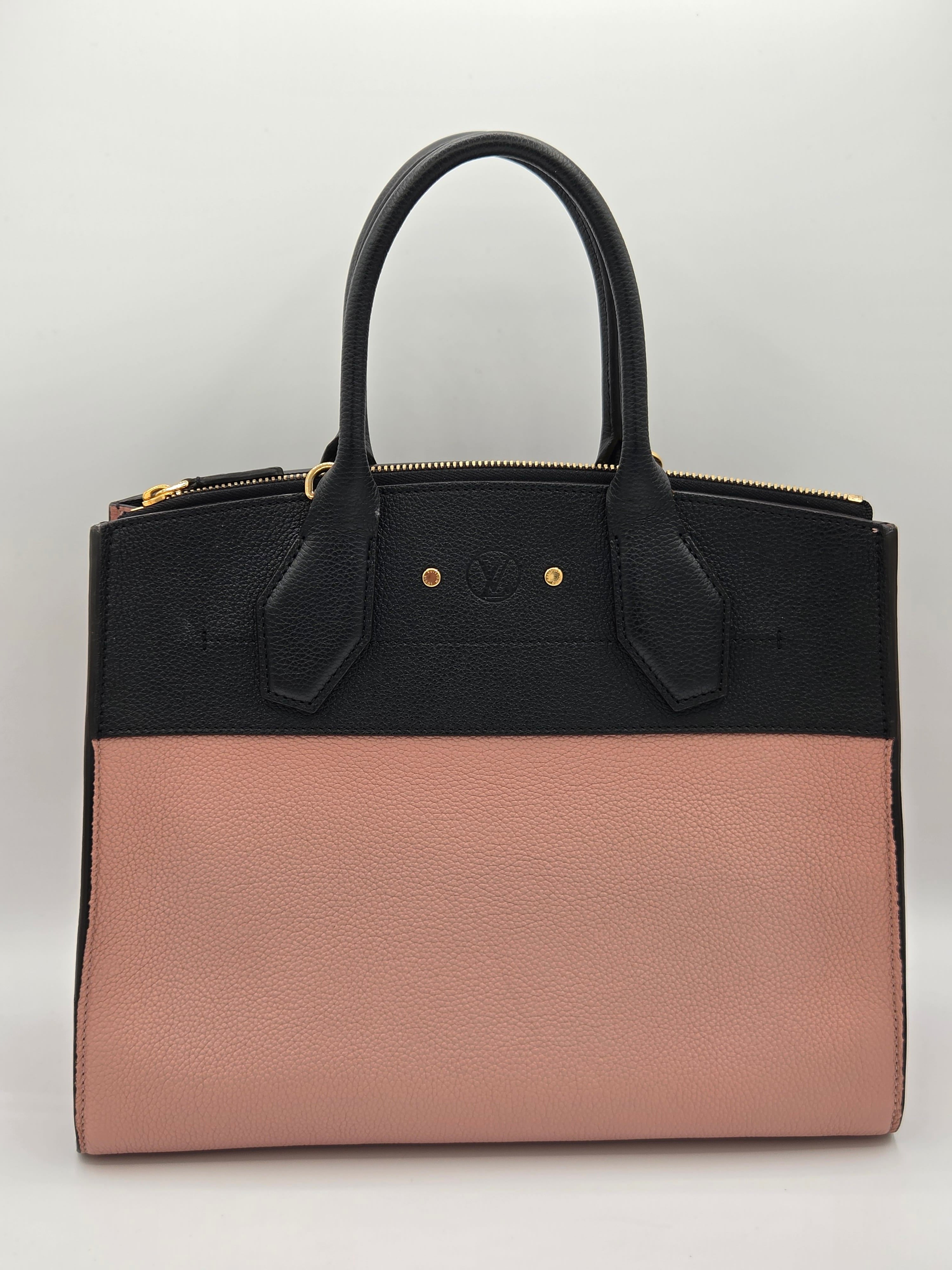 Two-toned black and pink handbag on a light gray background