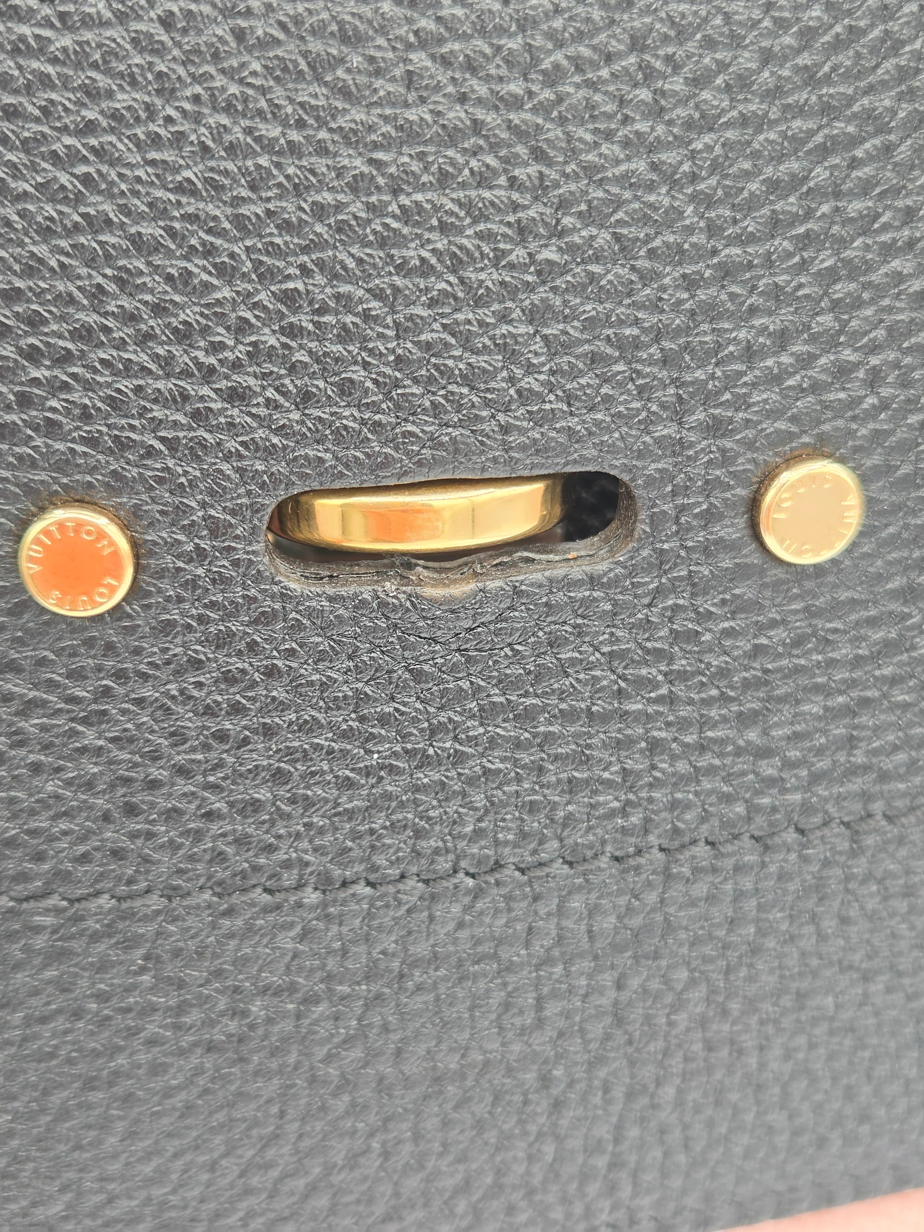 Close-up of a gold ring on gray textured fabric