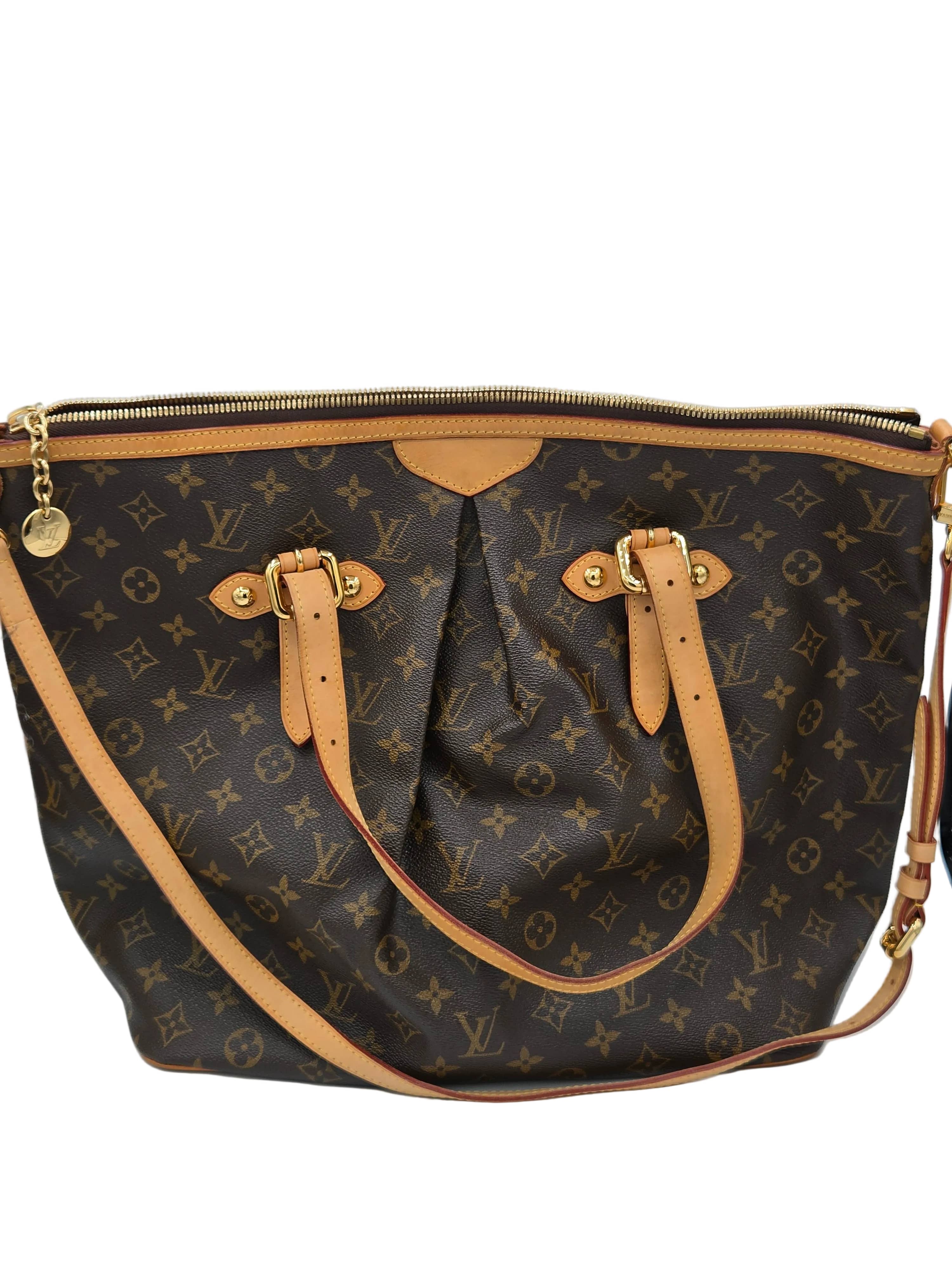 Designer handbag with monogram pattern on a light gray background