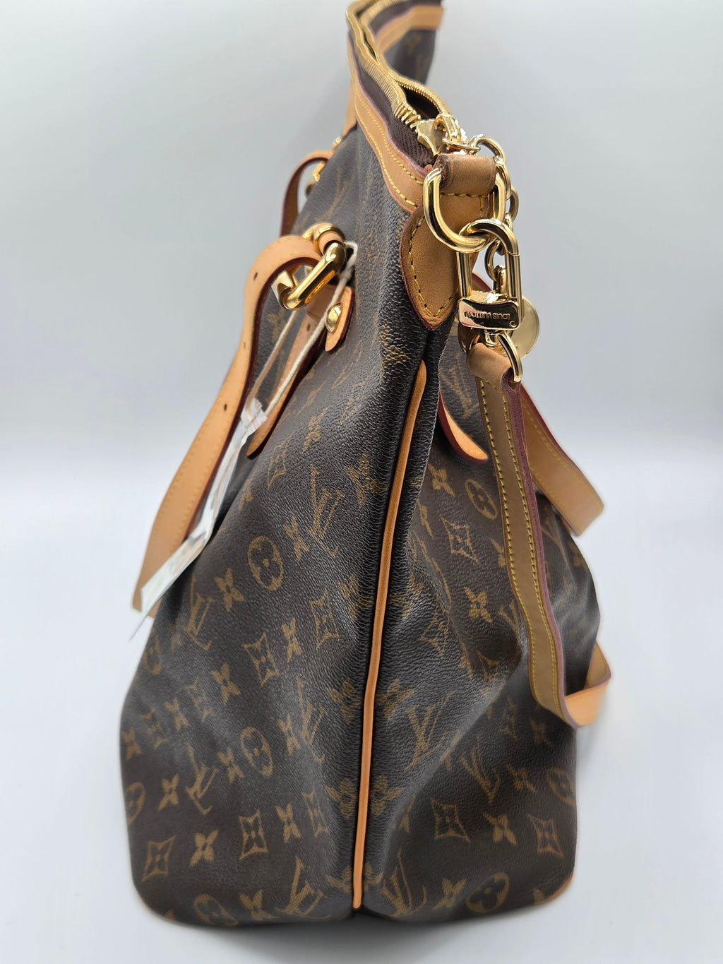 side view of monogram bag in brown