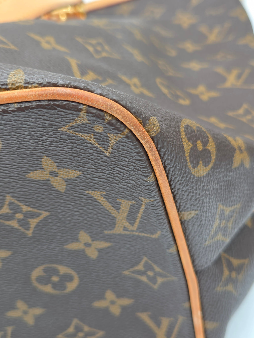 Close-up of a Louis Vuitton monogram bag with visible brand logo.